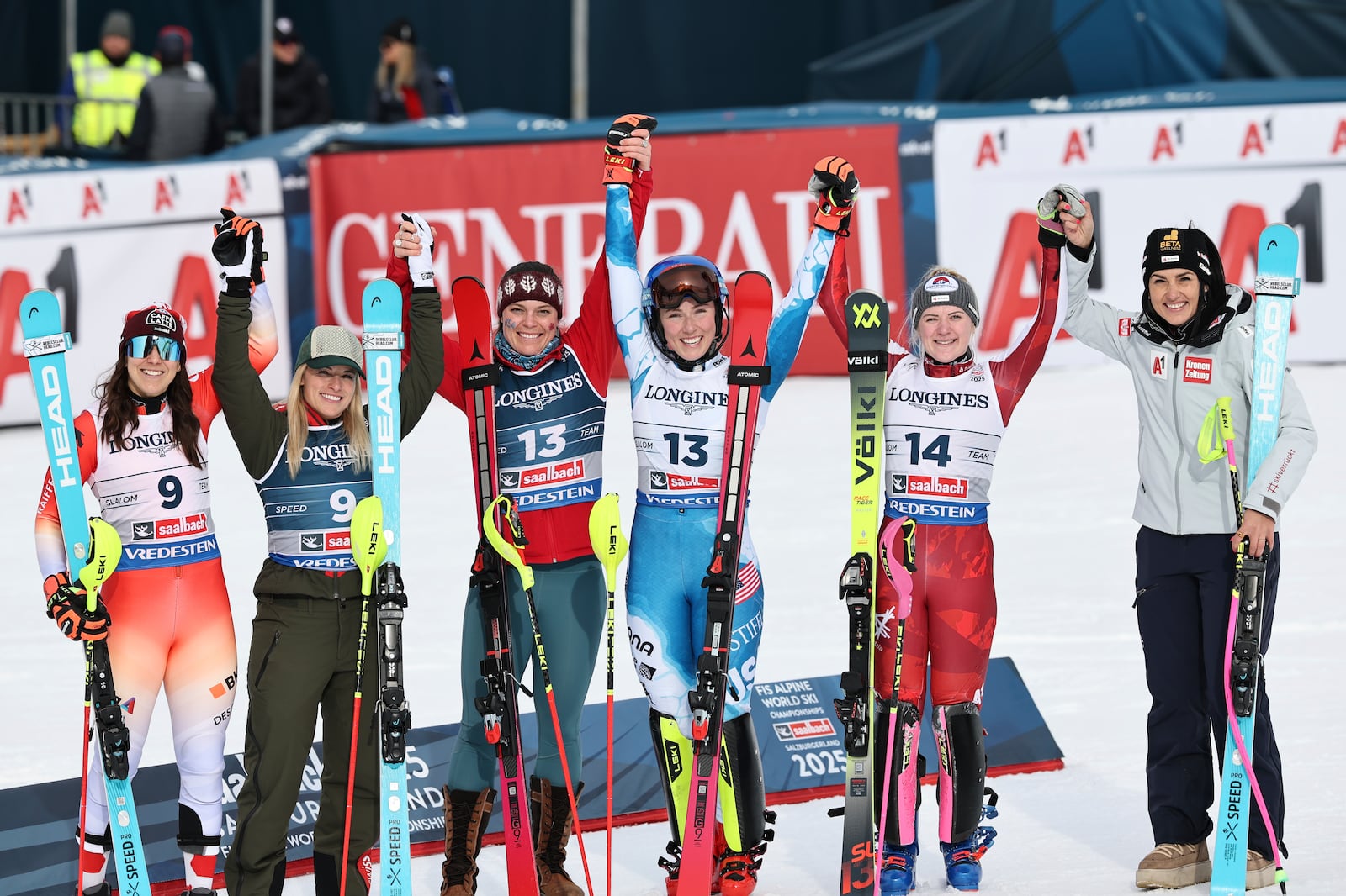 United States' Breezy Johnson and United States' Mikaela Shiffrin, center, gold medal winners of a women's team combined event, celebrate with silver medalists Switzerland's Wendy Holdener, left, and Switzerland's Lara Gut Behrami, second from left, and bronze medalists Austria's Katharina Truppe and Austria's Stephanie Venier, right, at the Alpine Ski World Championships, in Saalbach-Hinterglemm, Austria, Tuesday, Feb. 11, 2025. (AP Photo/Marco Trovati)