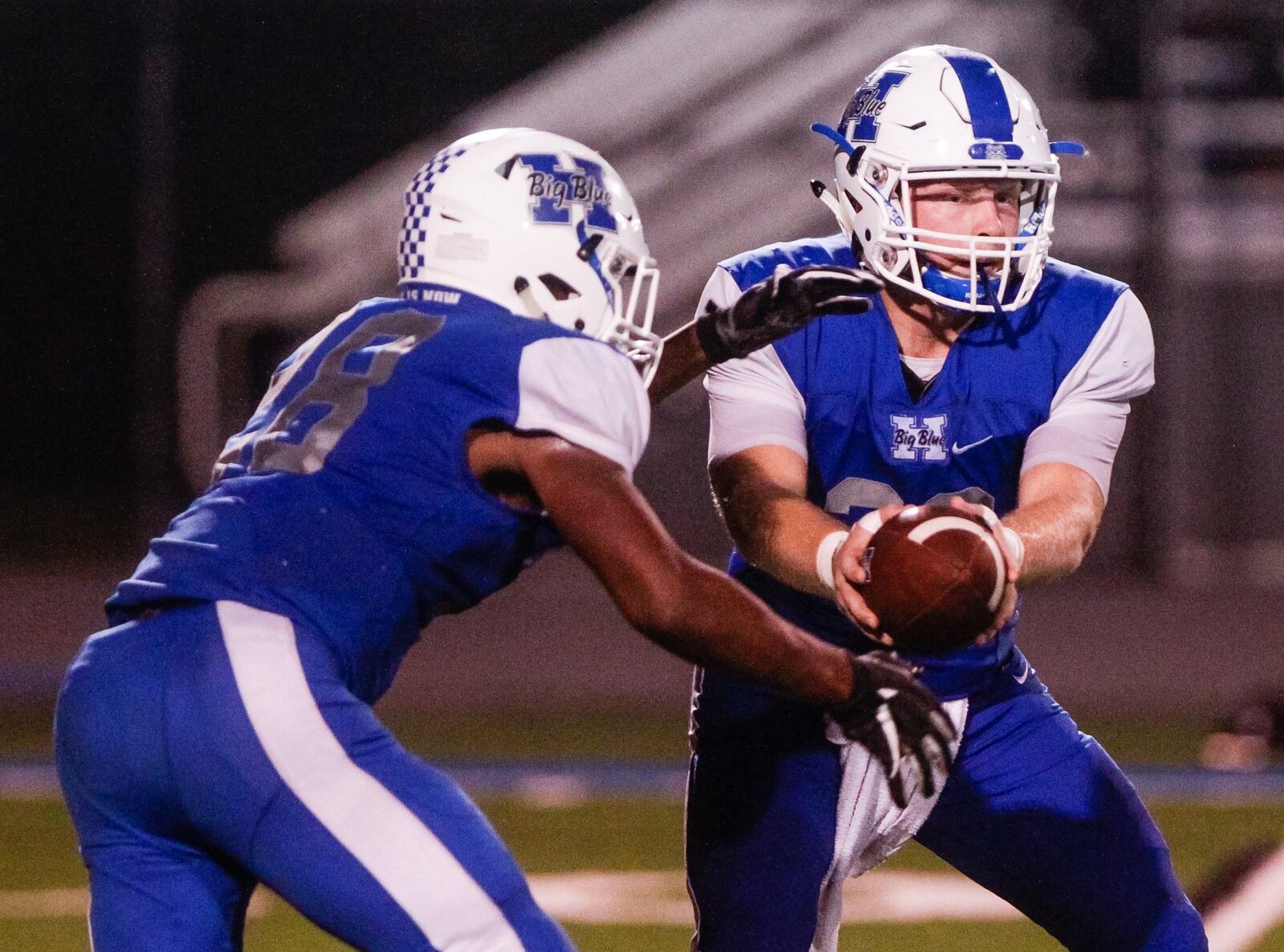 Hamilton quarterback Elijah Spradling hands the ball off to Keyshawn Stephens during their game against Middletown on Oct. 5 at Virgil Schwarm Stadium in Hamilton. HHS won 15-14. NICK GRAHAM/STAFF