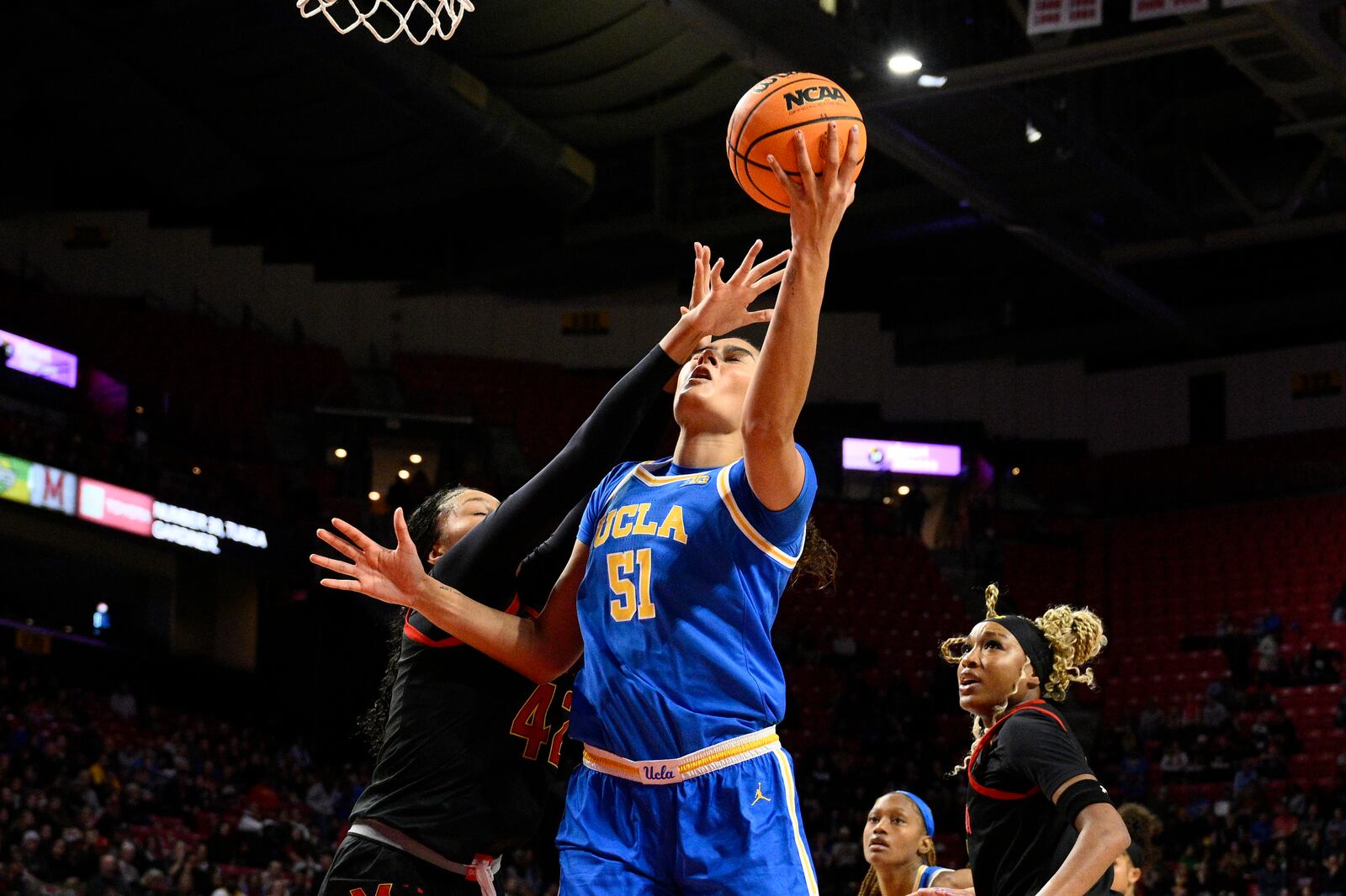 UCLA center Lauren Betts (51) goes to the basket against Maryland forward Amari DeBerry, left, during the first half of an NCAA college basketball game, Sunday, Jan. 26, 2025, in College Park, Md. (AP Photo/Nick Wass)