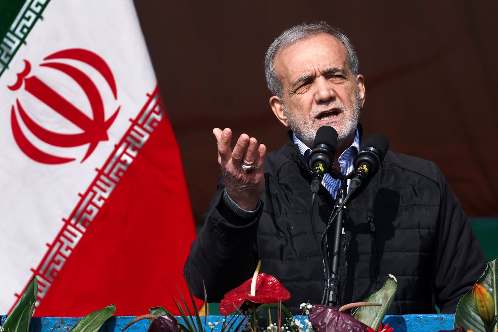 In this photo released by the Iranian Presidency Office, President Masoud Pezeshkian speaks during a rally commemorating anniversary of 1979 Islamic Revolution that toppled the late pro-U.S. Shah Mohammad Reza Pahlavi and brought Islamic clerics to power, in Tehran, Iran, Monday, Feb. 10, 2025. (Iranian Presidency Office via AP)