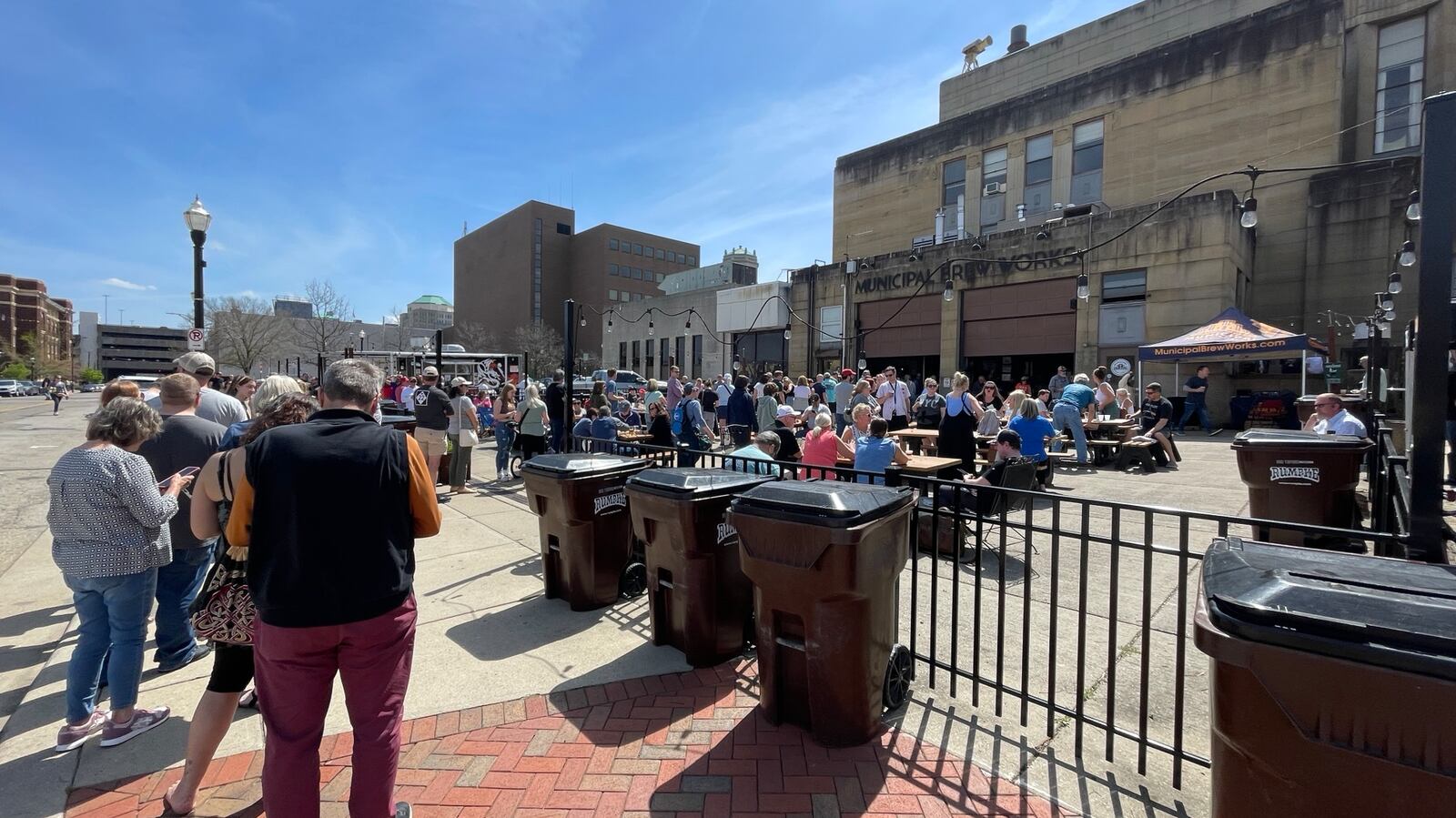 The crowd for the eclipse watchers are filling up downtown establishments and Marcum Park in Hamilton. This is the scene on Monday afternoon, April 8, 2024, at Municipal Brew Works. MICHAEL D. PITMAN/STAFF