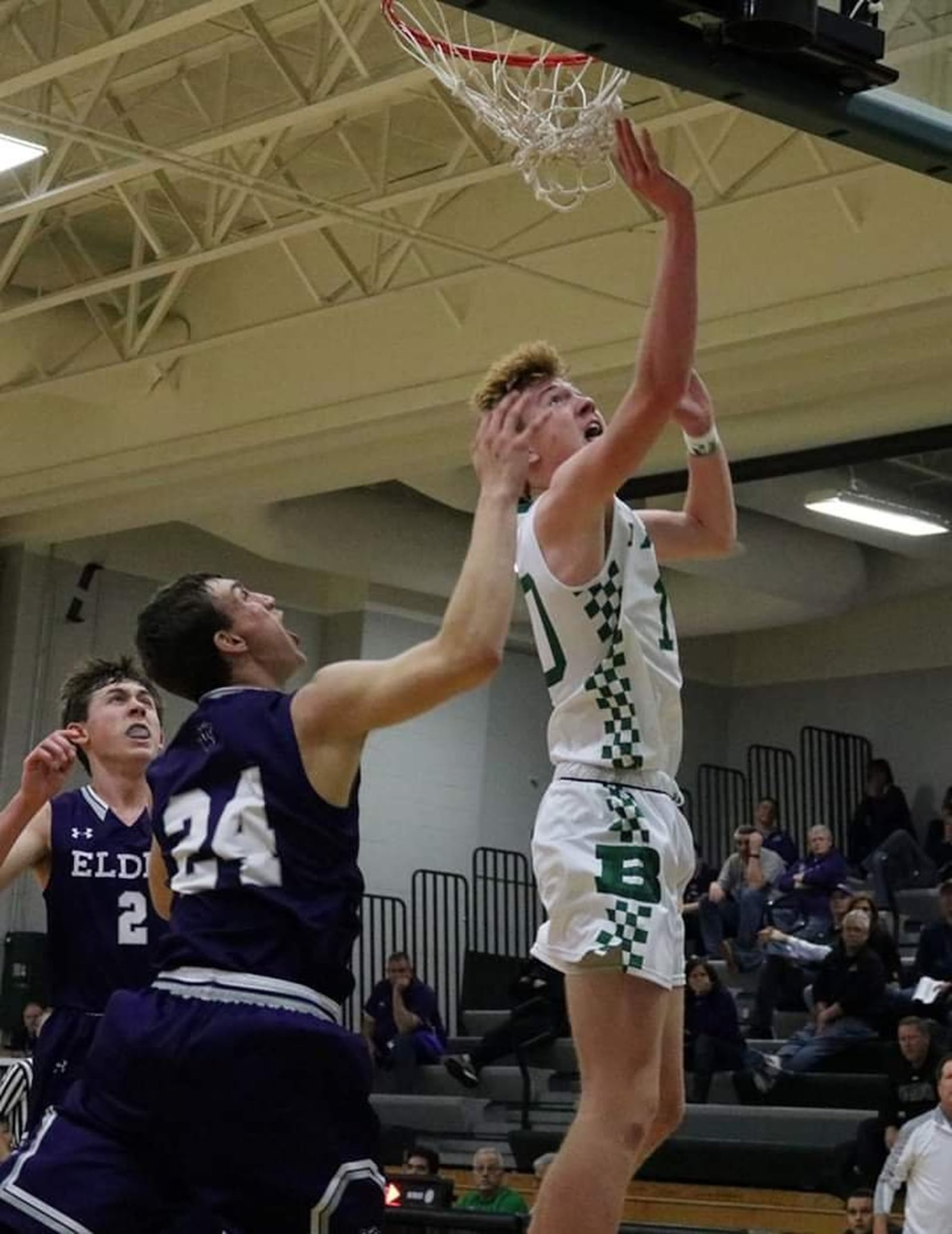 Badin’s Zach Switzer (10) gets past Elder’s Anthony Holmes (24) and takes a shot Tuesday night at Mulcahey Gym in Hamilton. Badin won 57-53. CONTRIBUTED PHOTO BY TERRI ADAMS