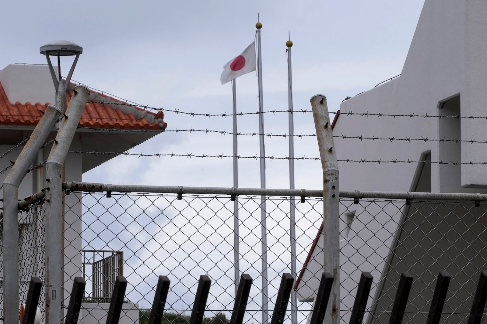 A Japanese flag flutters in the wind inside the Japan Self-Defense Forces (JSDF) base on Yonaguni, a tiny island on Japan’s western frontier, Friday, Feb. 14, 2025. (AP Photo/Ayaka McGill)