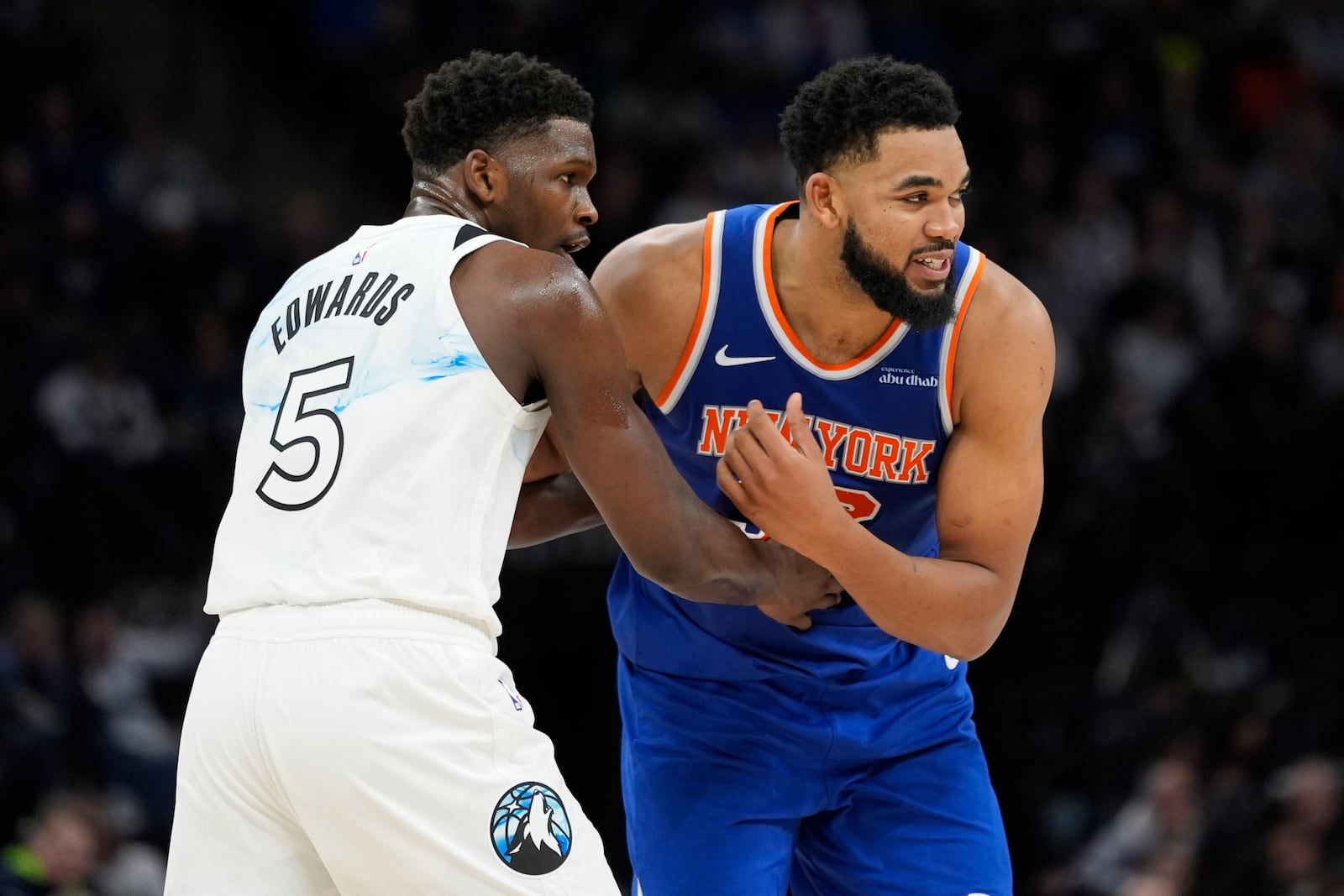 New York Knicks center Karl-Anthony Towns (32) is guarded by Minnesota Timberwolves guard Anthony Edwards (5) during the second half of an NBA basketball game, Thursday, Dec. 19, 2024, in Minneapolis. (AP Photo/Abbie Parr)