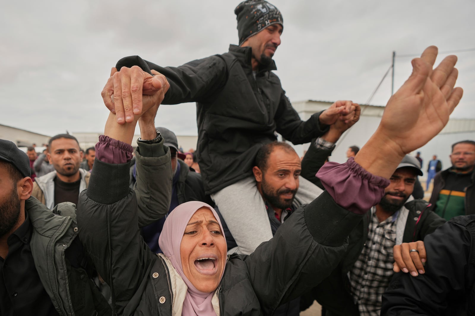 Freed Palestinian prisoners are greeted by a crowd as they arrive in the Gaza Strip after being released from an Israeli prison following a ceasefire agreement between Hamas and Israel in Khan Younis, souther Gaza Strip, Saturday Feb. 8, 2025. (AP Photo/Abdel Kareem Hana)