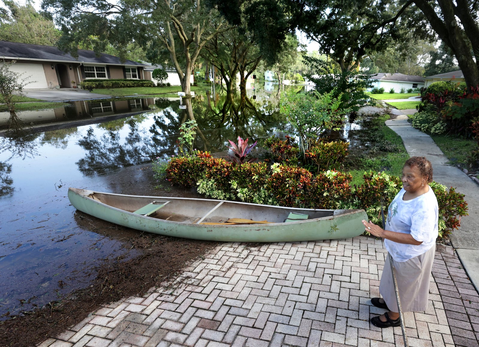 Spring Oaks resident Earline Gonzales talks about the rising waters from the Little Wekiva River in her flooded neighborhood in Altamonte Springs, Fla., Friday, Oct. 11, 2024. Central Florida rivers are forecast to rise in the coming days because of the excessive rainfall from Hurricane Milton. (Joe Burbank/Orlando Sentinel via AP)