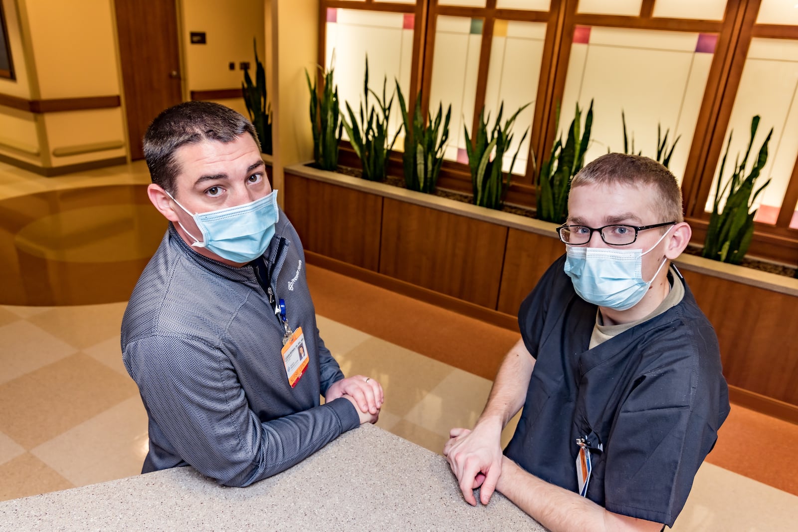 James "Logan" Beeman, left, a nurse manager at Atrium Medical Center, has been reunited with his brother-in-law, Brayden Hudnall, a specialist in the Ohio National Guard. Hudnall and other guardsmen were recently deployed to the Middletown hospital to assist in non-clinical duties due to COVID-19. Photo courtesy of Atrium Medical Center