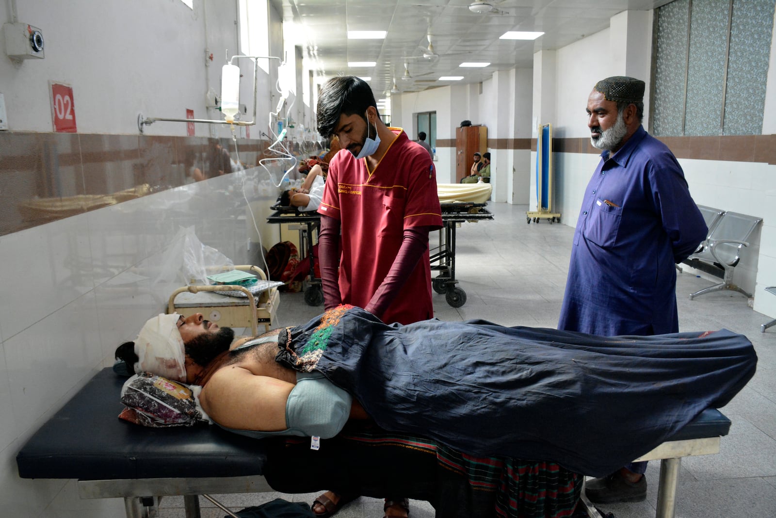 Injured men receive treatment at a hospital in Quetta, Pakistan, Friday, Oct. 11, 2024, following Thursday attack by gunmen in Balochistan province. (AP Photo/Arshad Butt)