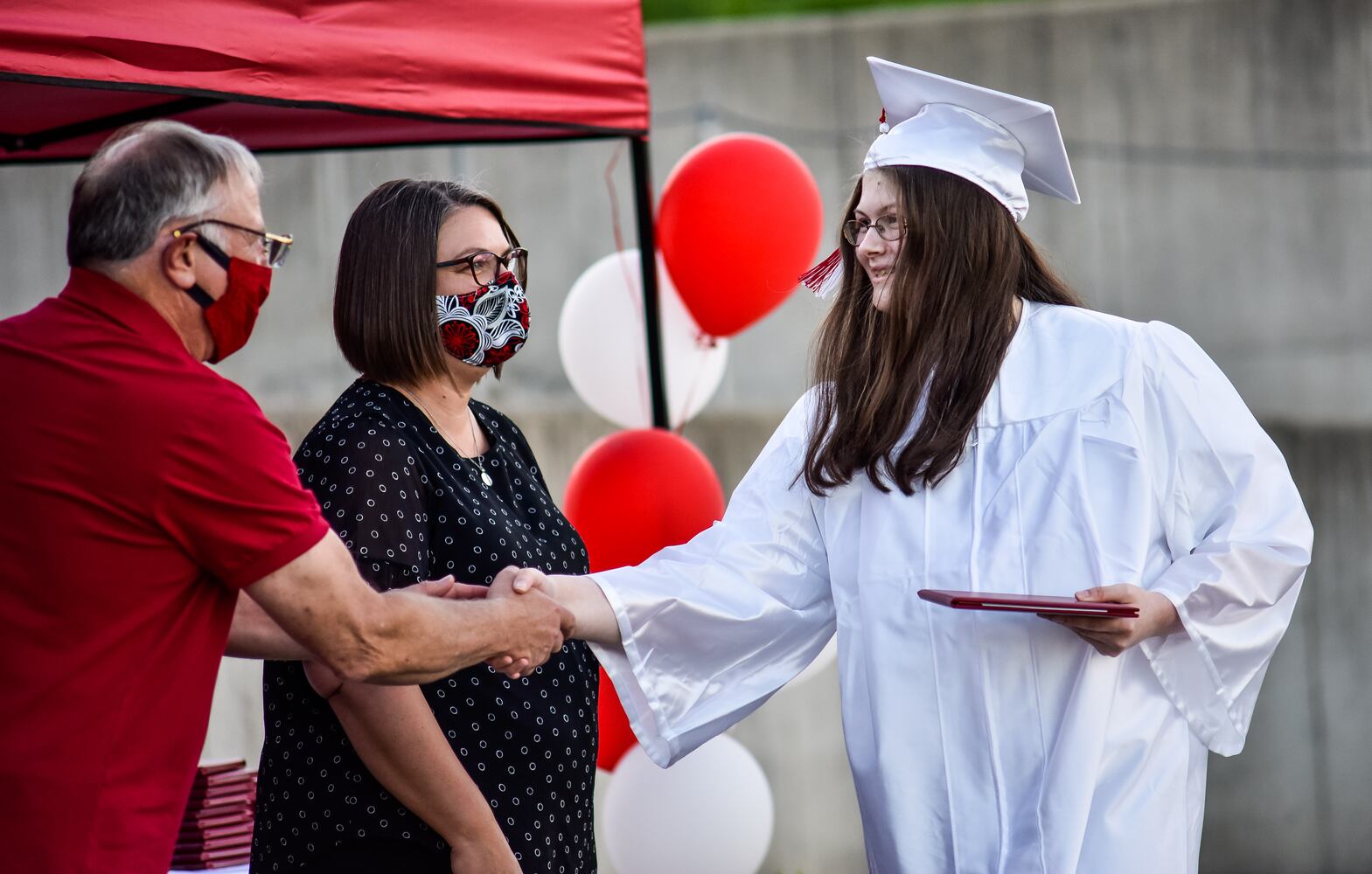 Madison High School drive-thru graduation ceremony at Land of Illusion