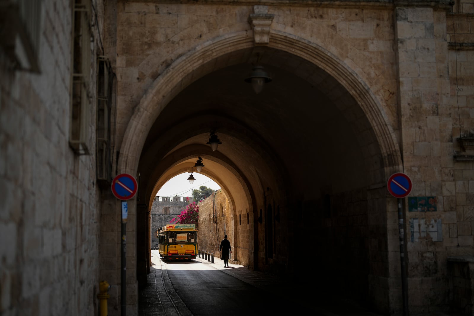 An Israeli ultra-orthodox walks through a narrow limestone passageway at the Armenian quarter in Jerusalem, Thursday, Nov. 21, 2024. (AP Photo/Francisco Seco)