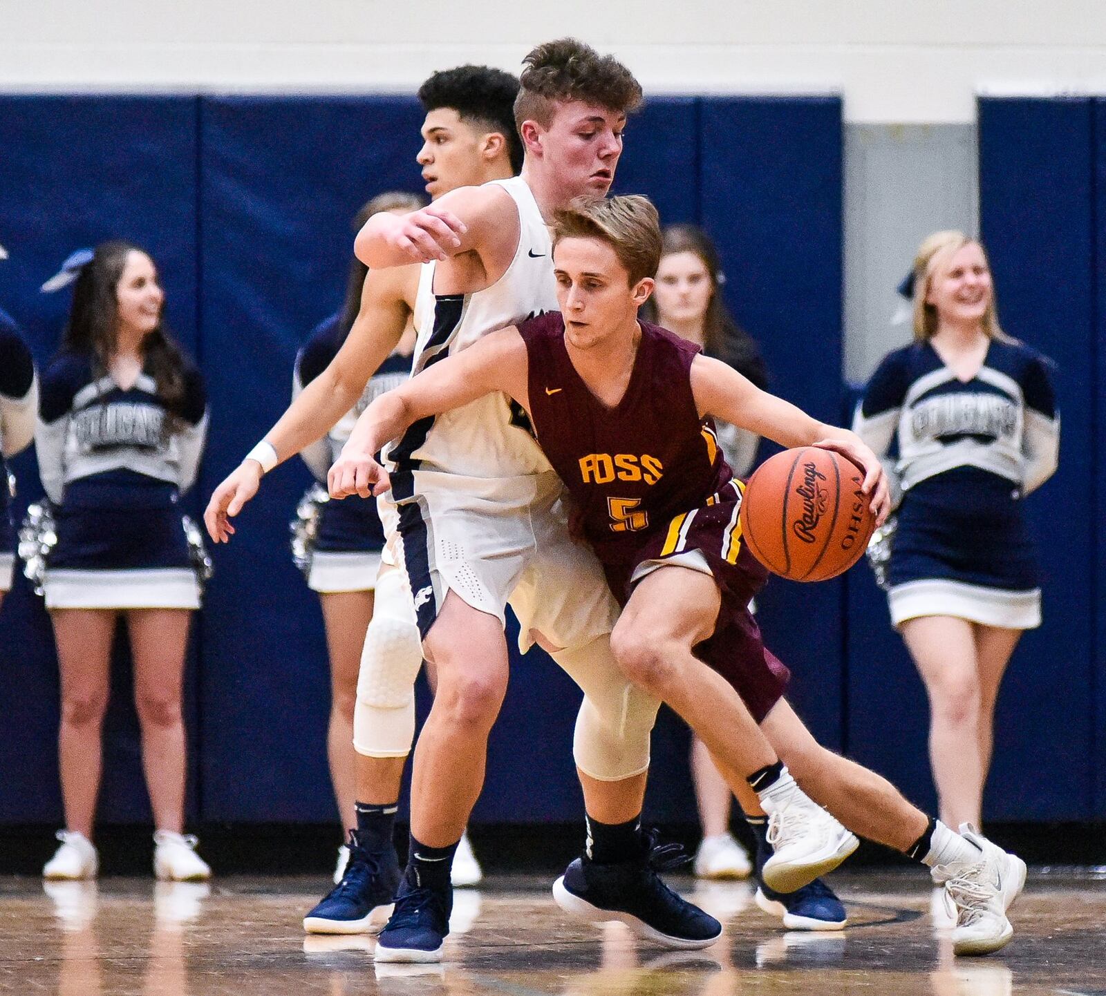 Ben Yeager of Ross dribbles around Edgewood’s Eric Brooks during Friday night’s game in St. Clair Township. Visiting Ross won 49-34. NICK GRAHAM/STAFF