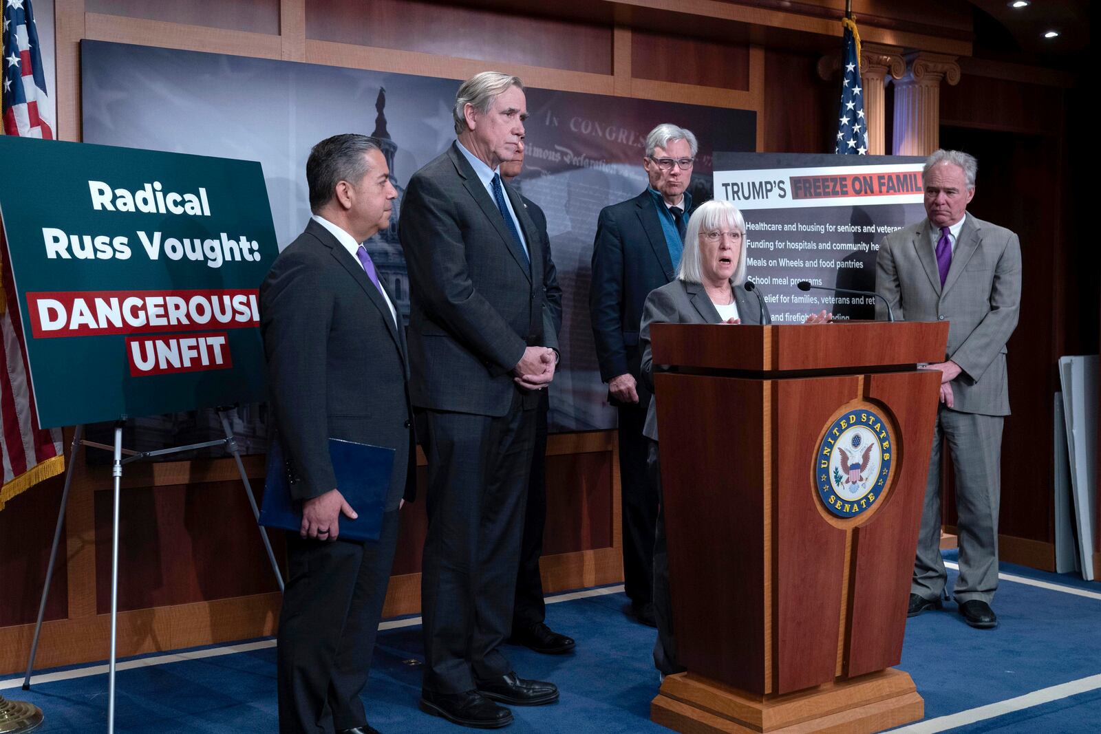 Sen. Patty Murray, D-Wash., speaks as Sen. Ben Ray Lujan, D-N.M., from left, Sen. Sen. Jeff Merkley, D-Ore., Sen. Alex Padilla, D-Calif., obstructed, Sen. Sheldon Whitehouse, D-R.I., and Sen. Tim Kaine, D-Va., listen during a news conference on Russ Vought's nomination at the Capitol in Washington, Thursday, Jan. 30, 2025. (AP Photo/Jose Luis Magana)