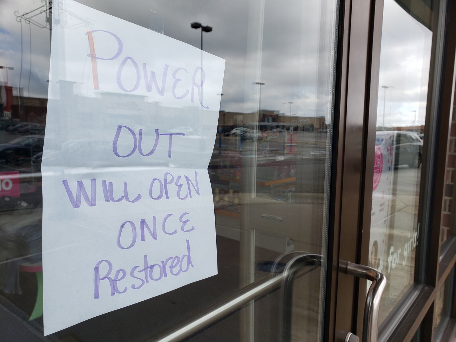 A sign on the window of Justice at Bridgewater Falls in Fairfield Twp. notes the business is without power on Friday, Feb. 7, 2020. NICK GRAHAM / STAFF