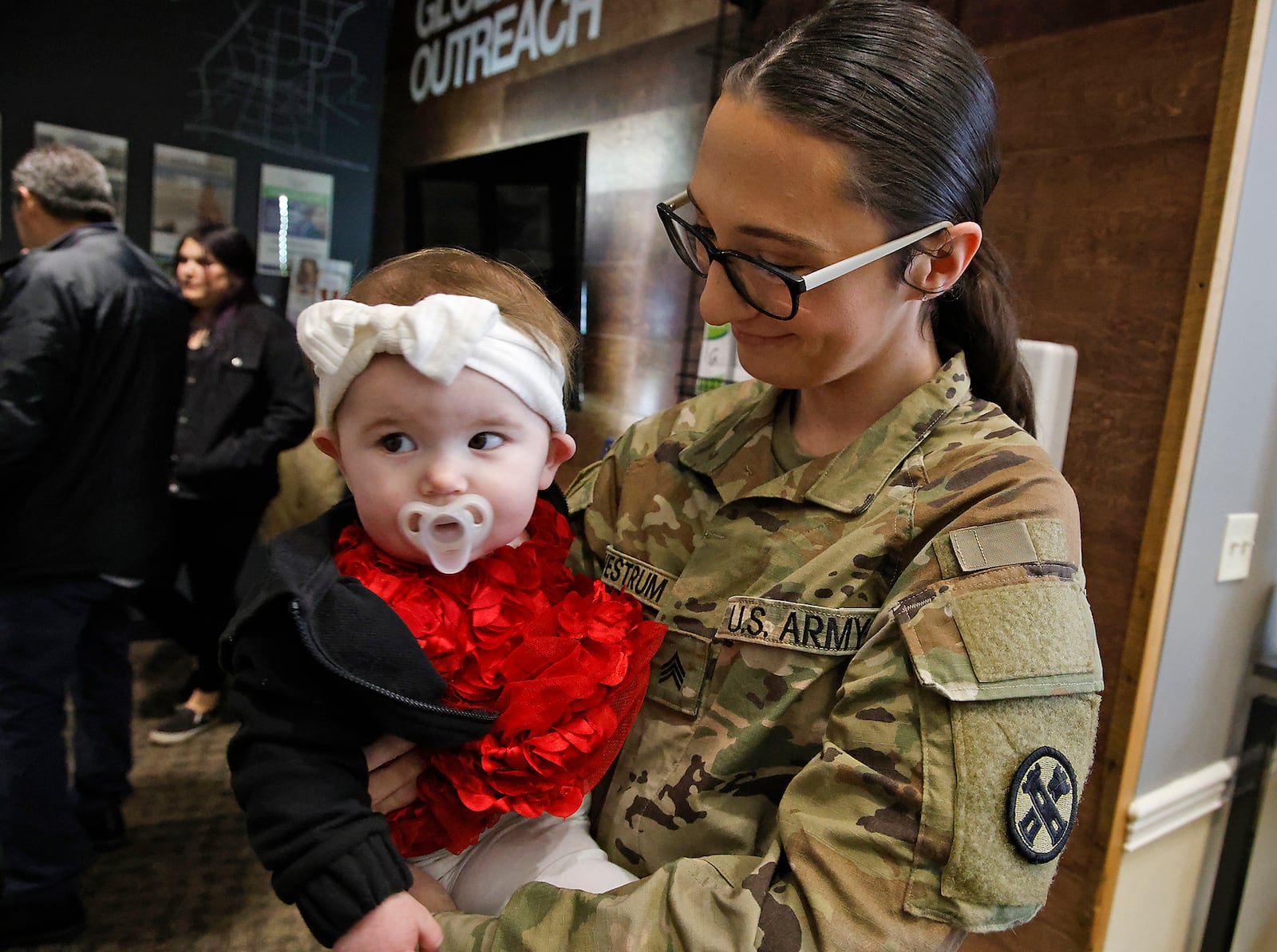 Sgt. Orchid Westrum spends some time with her niece, Avaia, during a Call to Duty Ceremony Friday, Jan. 12, at the First Christian Church. Westrum is being deployed with 30 other members of the Ohio National Guard's 1137th Signal Comapany, located in Springfield. BILL LACKEY/STAFF