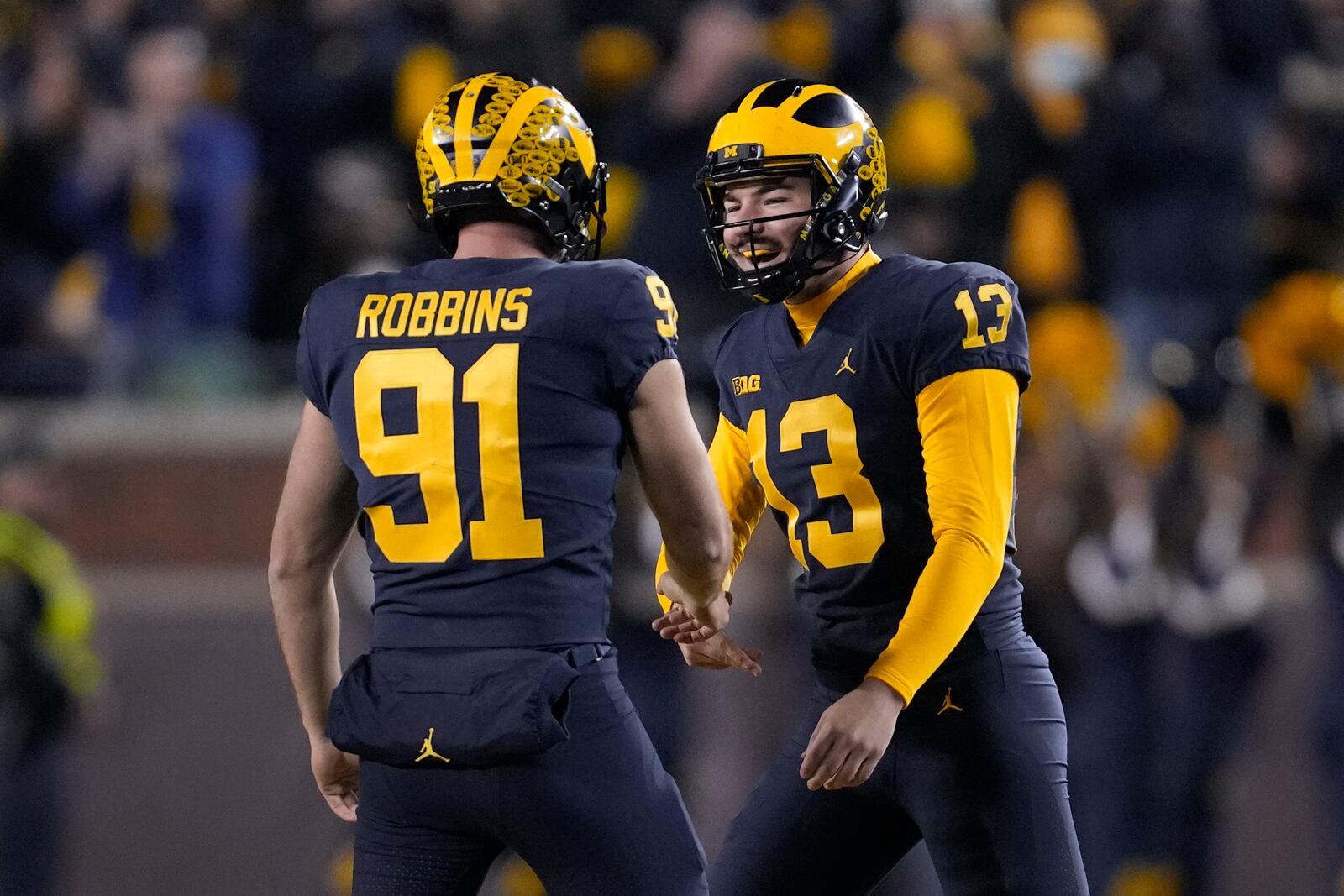 Michigan place kicker Jake Moody (13) celebrates his 54-yard field goal with Brad Robbins (91) in the second half of an NCAA college football game against the Michigan State in Ann Arbor, Mich., Saturday, Oct. 29, 2022. (AP Photo/Paul Sancya)