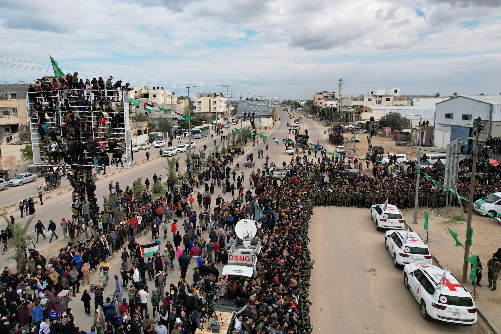 International red cross cars wait for Israeli captives, Ohad Ben Ami, Eli Sharabi and Or Levy, who have been held hostage by Hamas in Gaza since October 7, 2023, in Deir al-Balah, central Gaza Strip, Saturday Feb. 8, 2025. (AP Photo/Mohammad Abu Samra)