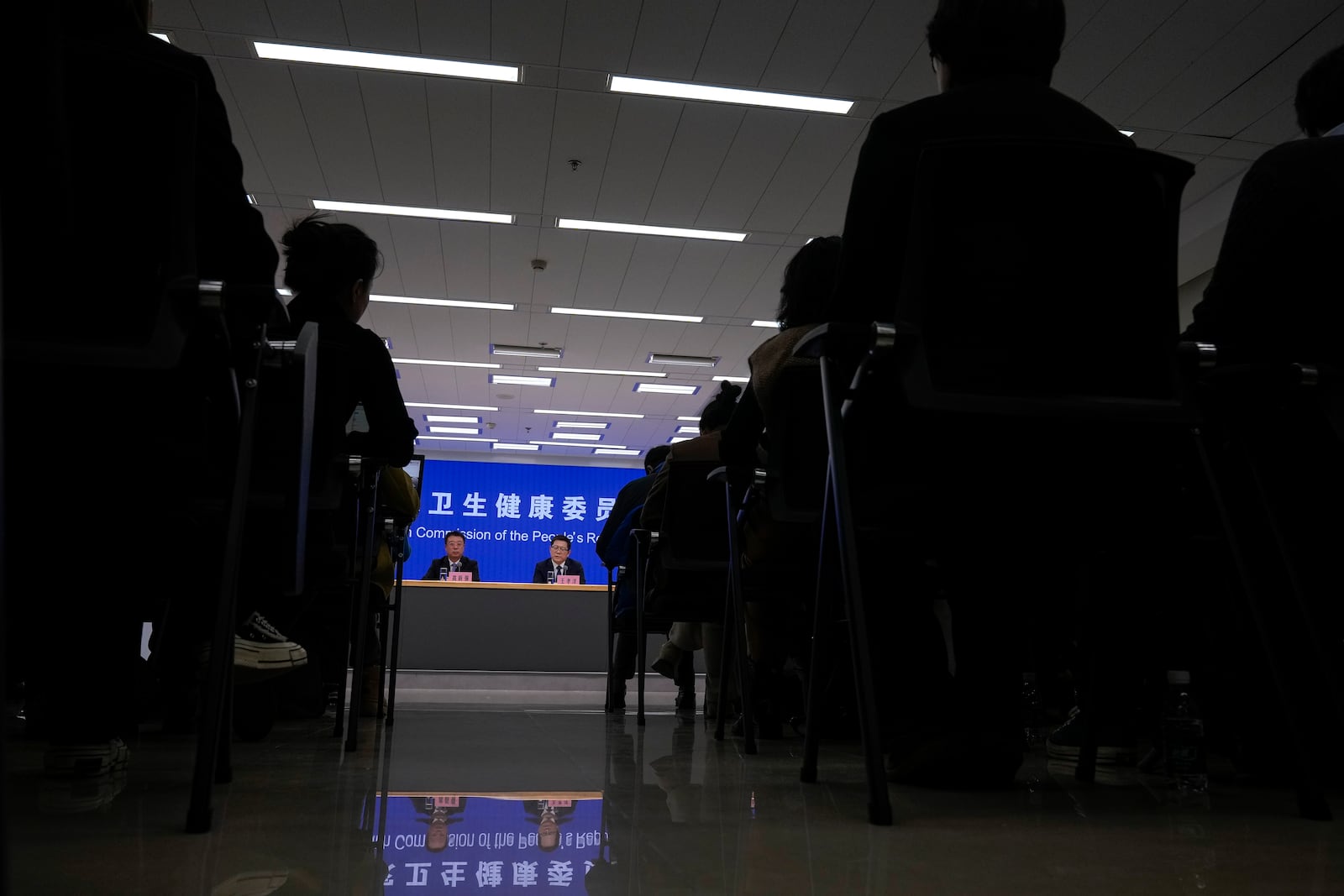 Gao Xinqiang, deputy director of the Department of Medical Emergency Response of the health commission, left, speaks to reporters during a press briefing by the National Health Commission as concerns surfaced in recent days over a surge in human metapneumovirus (HMPV) infections in northern China after images circulated online of hospitals overrun with masked patients, in Beijing, Sunday, Jan. 12, 2025. (AP Photo/Andy Wong)