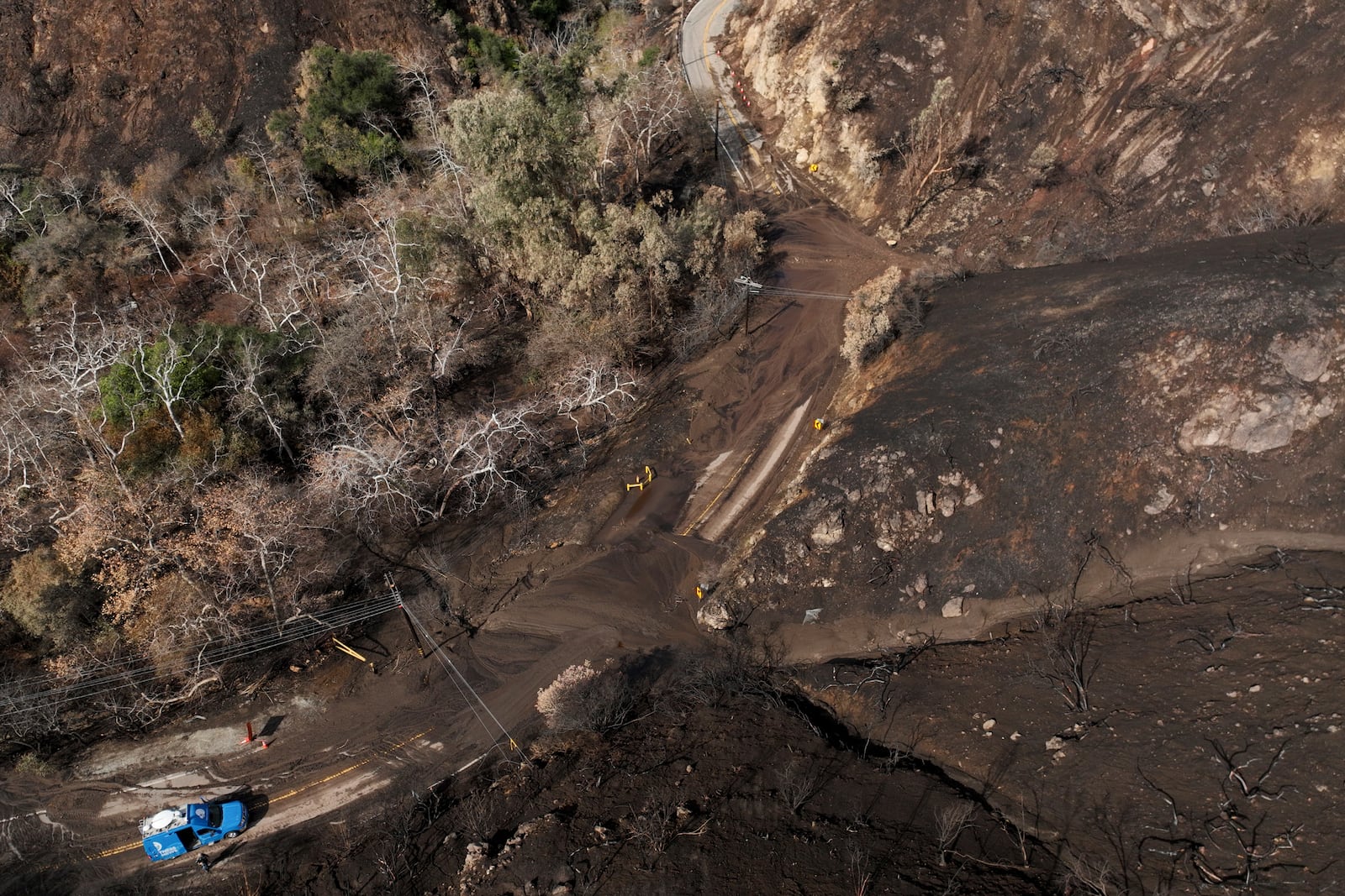 Mud covers Topanga Canyon Rd. on the Palisades Fire burn area after a series of weekend storms Monday, Jan. 27, 2025 near Malibu, Calif. (AP Photo/Jae C. Hong)