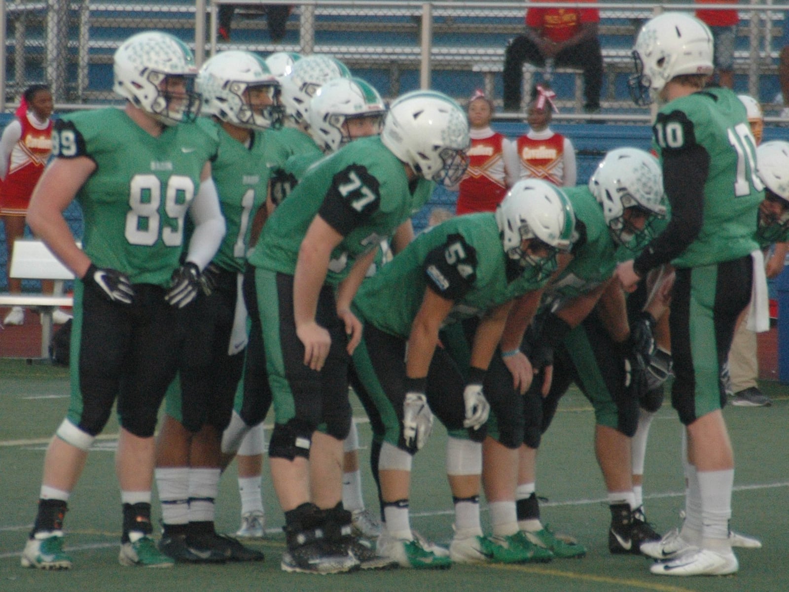 Badin quarterback Zach Switzer (10) talks to the offense in a huddle Saturday night during the Rams’ 24-7 victory over Purcell Marian at Monroe. RICK CASSANO/STAFF