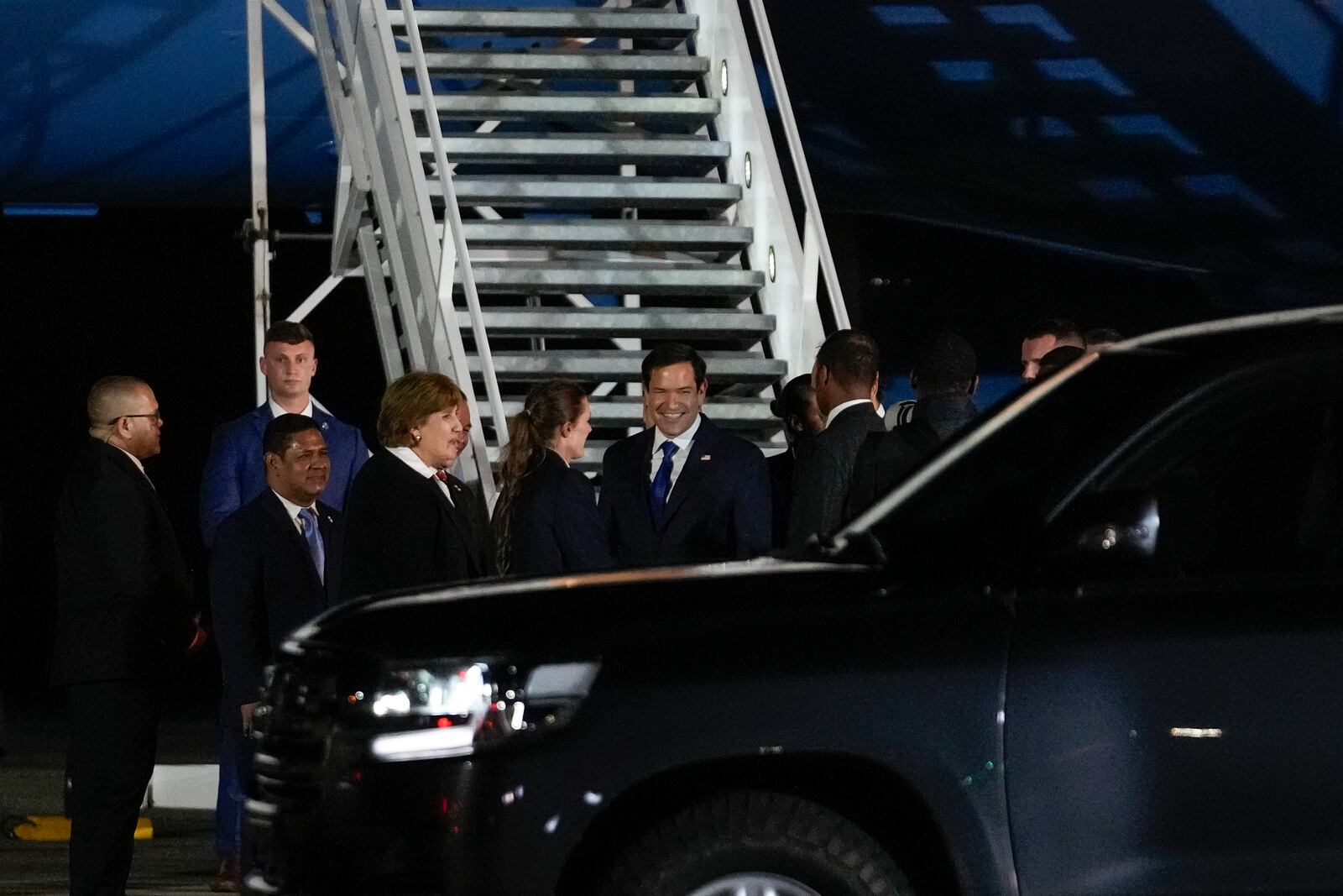 U.S. Secretary of State Marco Rubio, center, smiles as he is received at the international airport in Panama Pacifico, Panama, Saturday, Feb. 1, 2025. (AP Photo/Matias Delacroix)