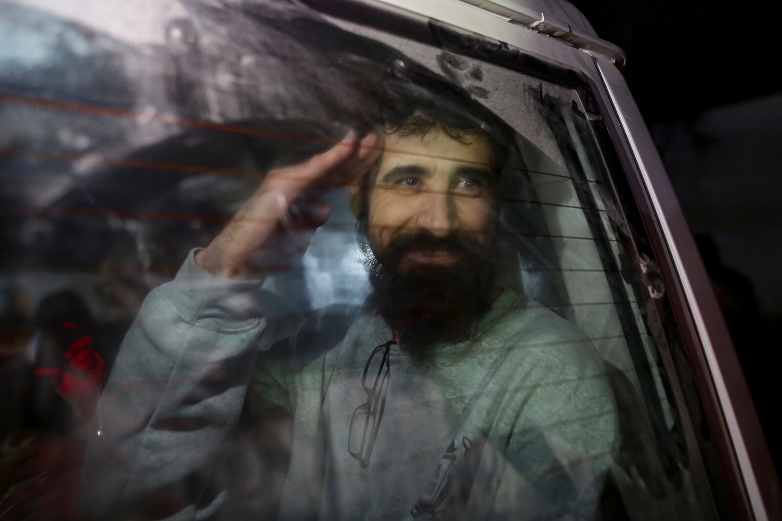 A freed Palestinian prisoner waves as he arrives in the Gaza Strip after being released from an Israeli prison following a ceasefire agreement between Hamas and Israel in Khan Younis, Thursday, Jan. 30, 2025. (AP Photo/Jehad Alshrafi)