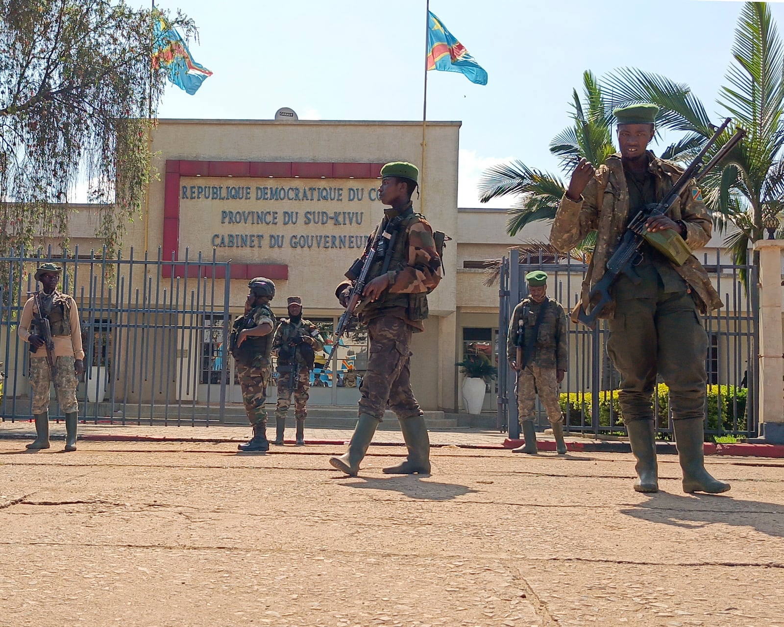 M23 rebels guard outside the South Kivu province administrative office, at the centre of east Congo's second-largest city, Bukavu, Sunday, Feb. 16, 2025. (AP Photo/Janvier Barhahiga)