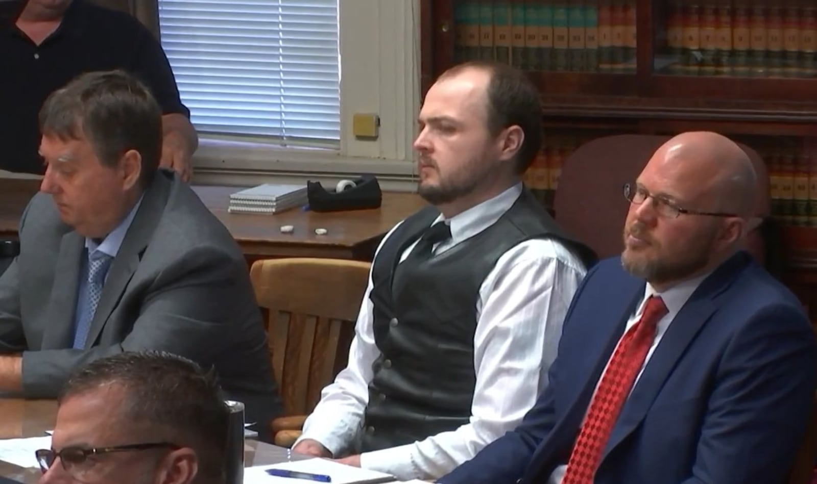 George Wagner IV, middle, is seen in court in Pike County on Monday, Sept. 12, 2022. Wagner faces multiple counts in the 2016 murders of eight members of the Rhoden family. LIVE FEED PHOTO/WCPO