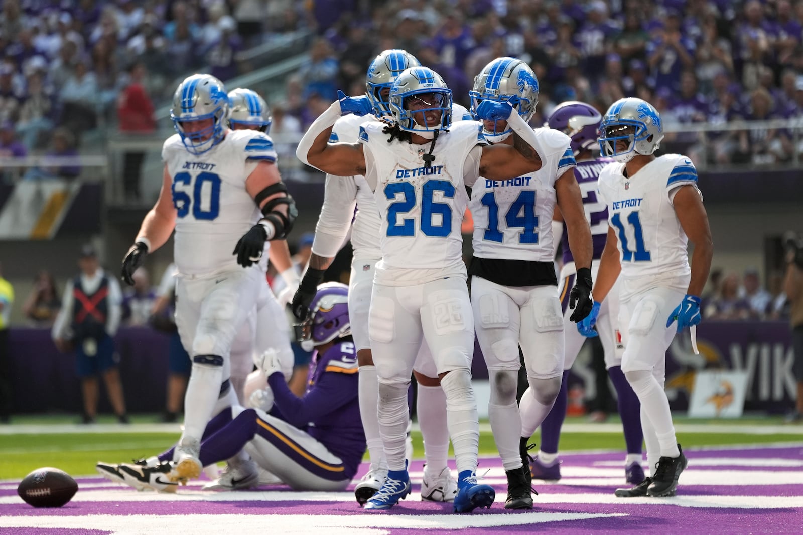 Detroit Lions running back Jahmyr Gibbs (26) celebrates his eight-yard touchdown run against the Minnesota Vikings during the first half of an NFL football game Sunday, Oct. 20, 2024, in Minneapolis. (AP Photo/Abbie Parr)