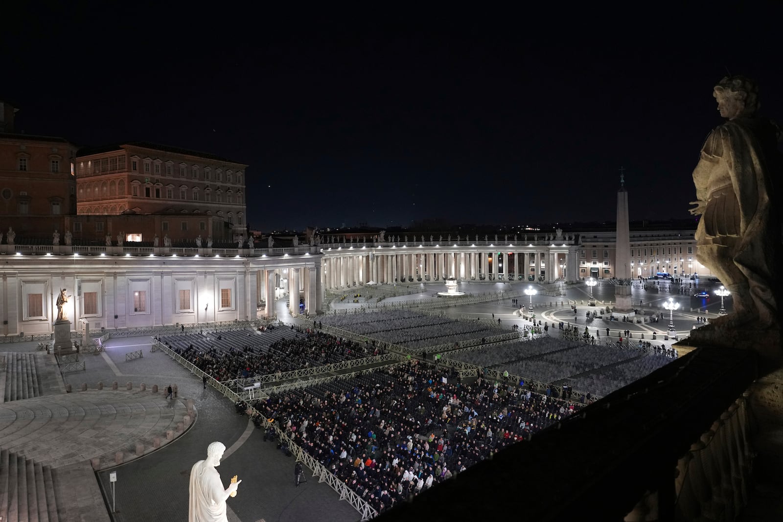 People attend as The Pope's vicar for the dioceses of Rome Cardinal Baldassarre Reina holds a rosary prayer for the health of Pope Francis in St Peter's Square at The Vatican, Thursday, Feb. 27, 2025. (AP Photo/Kirsty Wigglesworth)