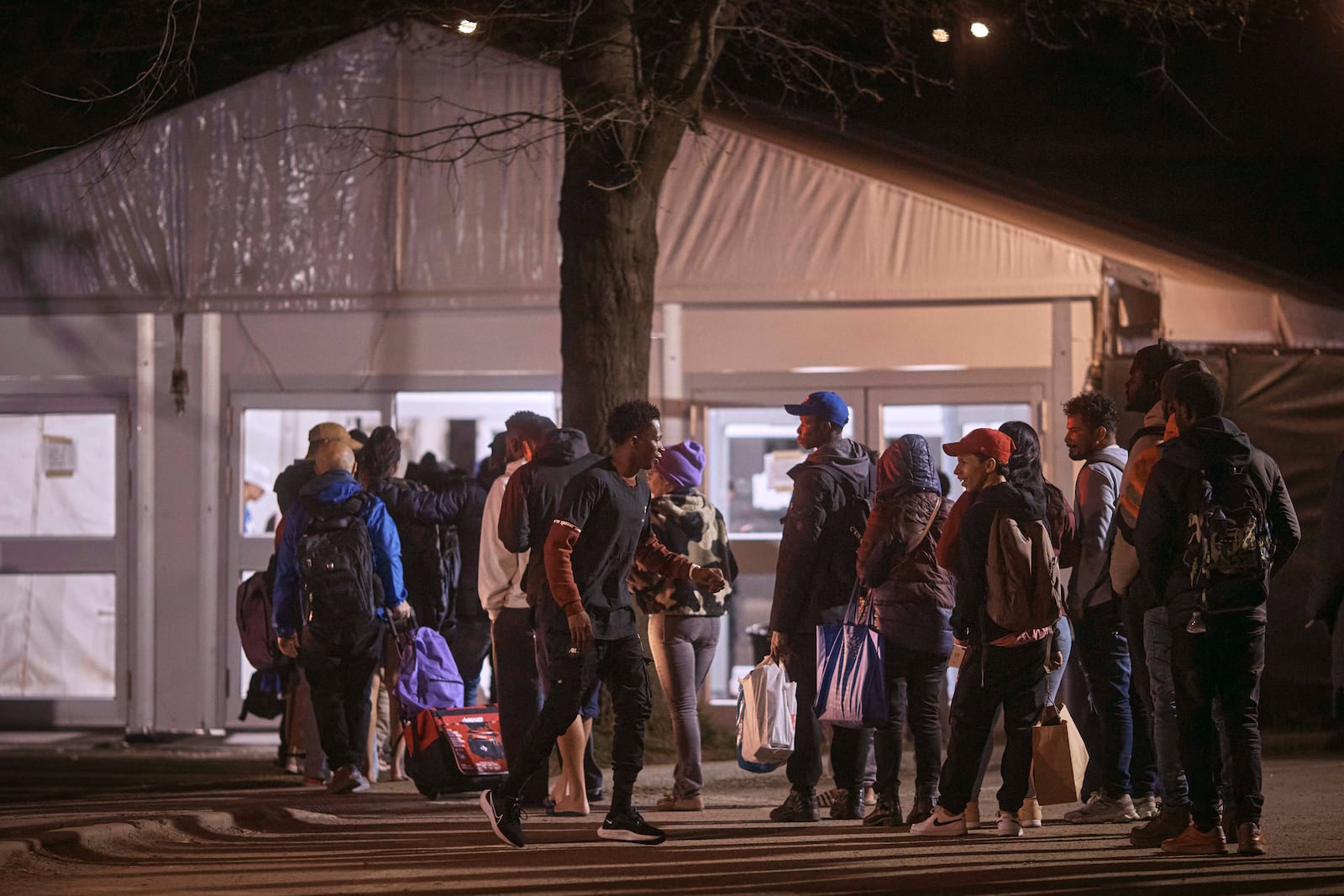 FILE - Migrants queue to enter the migrant shelter on Randall's Island, April 9, 2024, in New York. (AP Photo/Andres Kudacki, File)