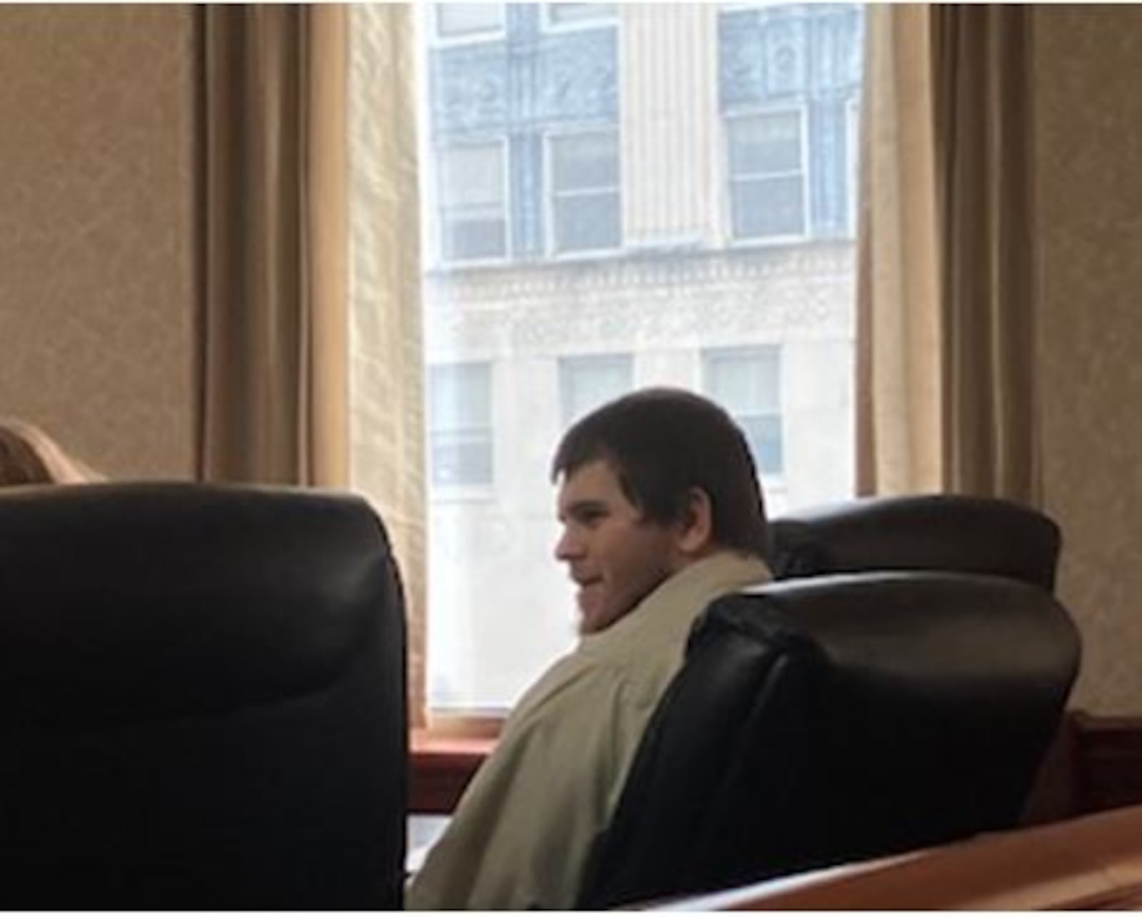 John Lincoln Powers talks with his defense attorney while waiting forjury selection to begin Tuesday in his murder trial in Butler County Common Pleas Court. LAUREN PACK/STAFF.