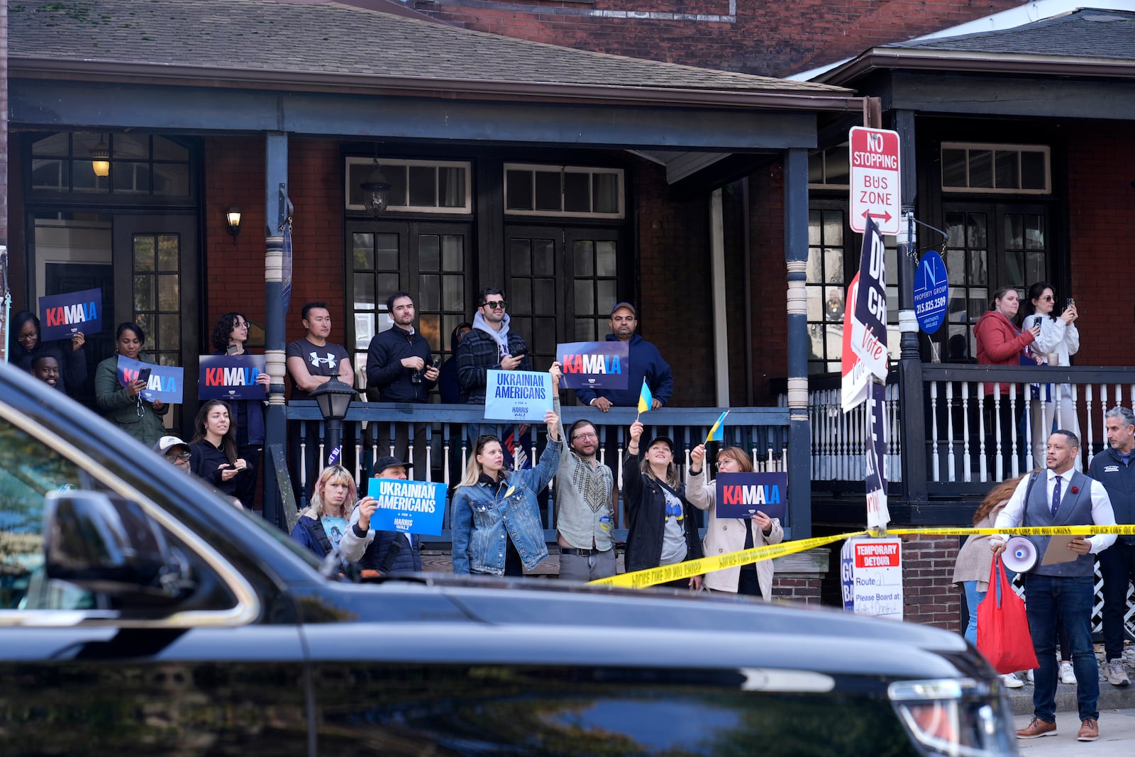 Supporters hold signs outside Philly Cuts barbershop as Democratic presidential nominee Vice President Kamala Harris visits during a campaign stop, Sunday, Oct. 27, 2024, in Philadelphia. (AP Photo/Susan Walsh)