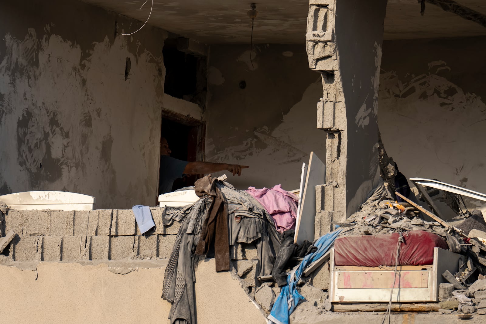 A man surveys a damaged room after projectiles fired from Lebanon hit a home in Tira, central Israel, Saturday, Nov. 2, 2024. (AP Photo/Ariel Schalit)