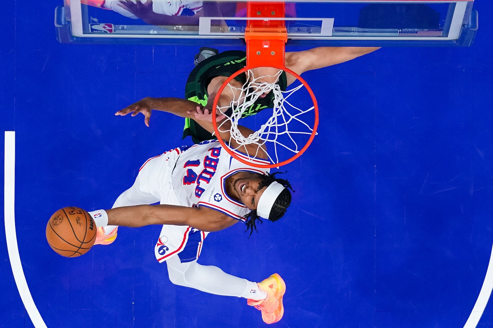 Philadelphia 76ers' Ricky Council IV (14) goes up to shoot against Boston Celtics' Derrick White, top, during the first half of an NBA basketball game, Sunday, Feb. 2, 2025, in Philadelphia. (AP Photo/Chris Szagola)