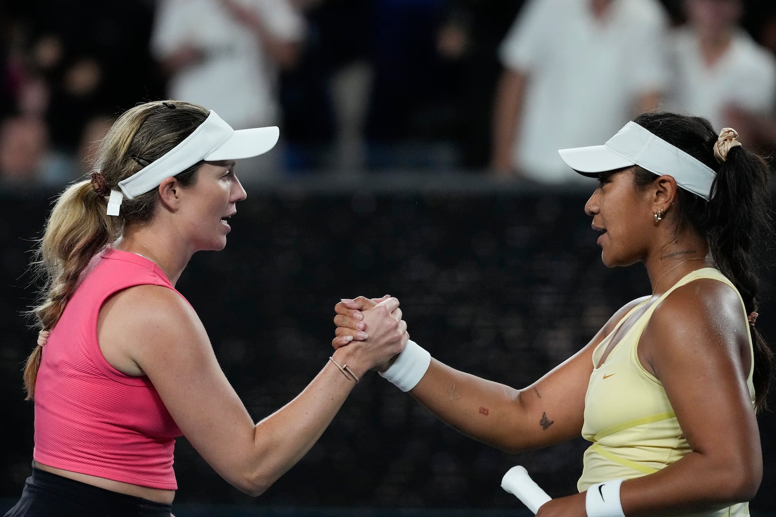 Danielle Collins, left, of the U.S. is congratulated by Destanee Aiava of Australia following their second round match at the Australian Open tennis championship in Melbourne, Australia, Thursday, Jan. 16, 2025. (AP Photo/Manish Swarup)