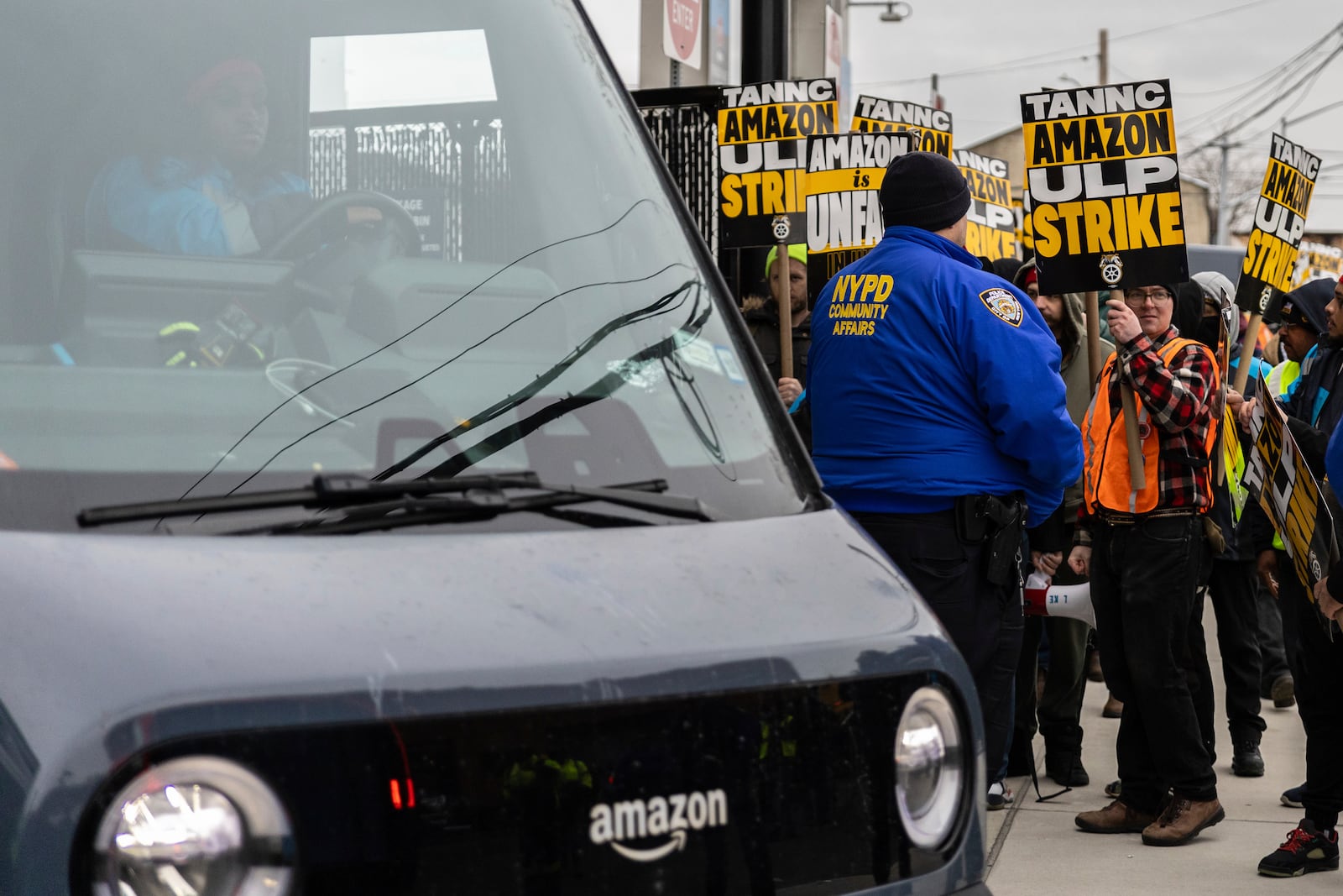 Amazon workers and members of the International Brotherhood of Teamsters picket in front of the Amazon fulfillment center in the Queens borough of New York, Friday, Dec. 20, 2024. (AP Photo/Stefan Jeremiah)