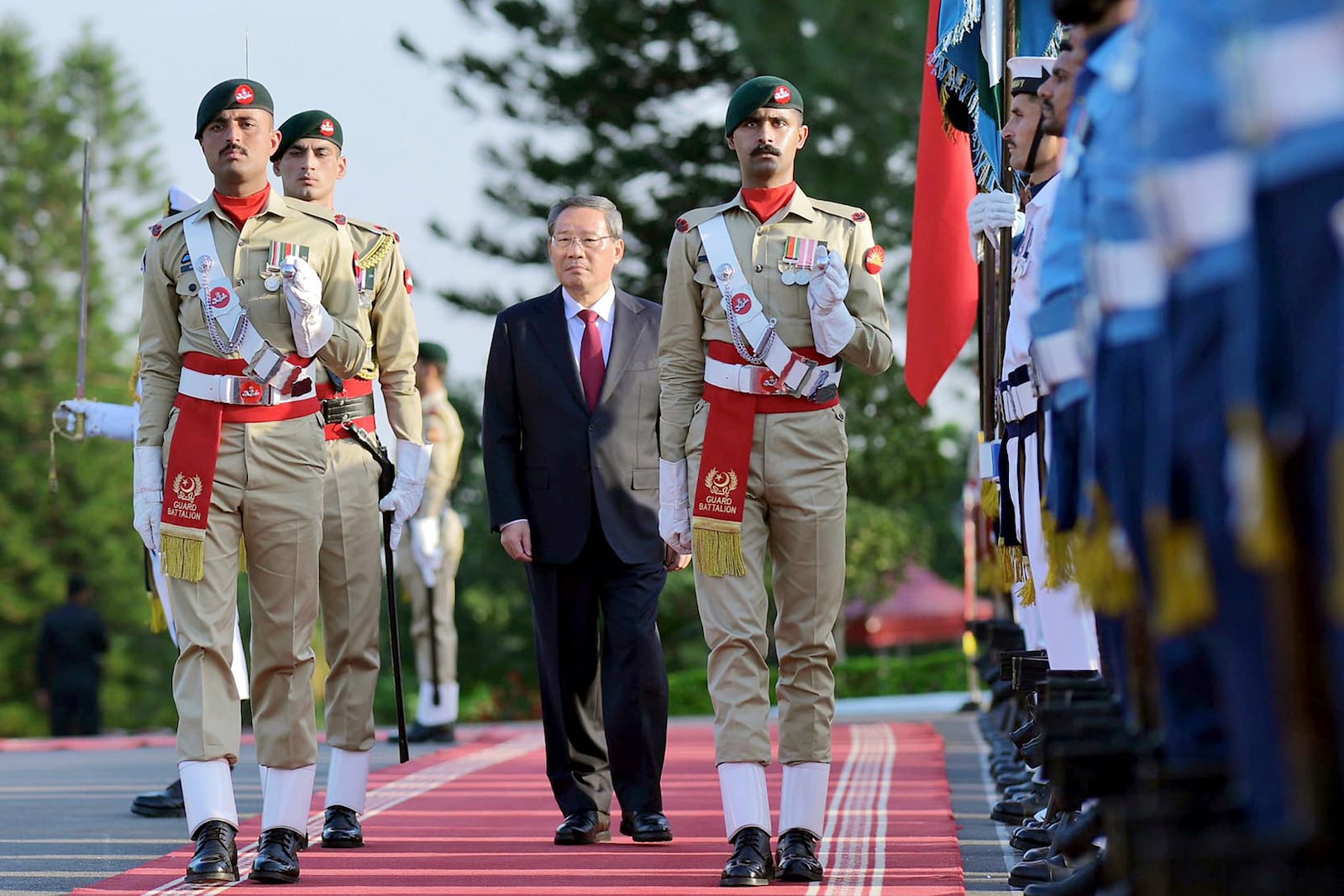 In this photo released by the Press Information Department, visiting China's Premier Li Qiang reviews the guard of honor during a welcome ceremony, in Islamabad, Pakistan, Monday, Oct. 14, 2024. (Press Information Department via AP)