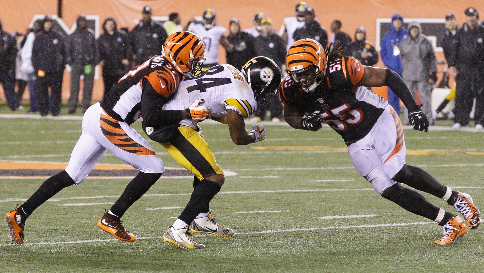 FILE - In this Jan. 10, 2016, file photo, Cincinnati Bengals' Vontaze Burfict (55), right, runs into Pittsburgh Steelers' Antonio Brown (84) during the second half of an NFL wild-card playoff football game in Cincinnati. Burfict was called for a penalty on the play. The Steelers have ruled out All-Pro wide receiver Antonio Brown from Sunday's AFC divisional playoff game against Denver while he recovers from a concussion. Brown left last weekend's wild-card win over Cincinnati after taking a shot to the head from Bengals linebacker Vontaze Burfict. (AP Photo/John Minchillo, File)