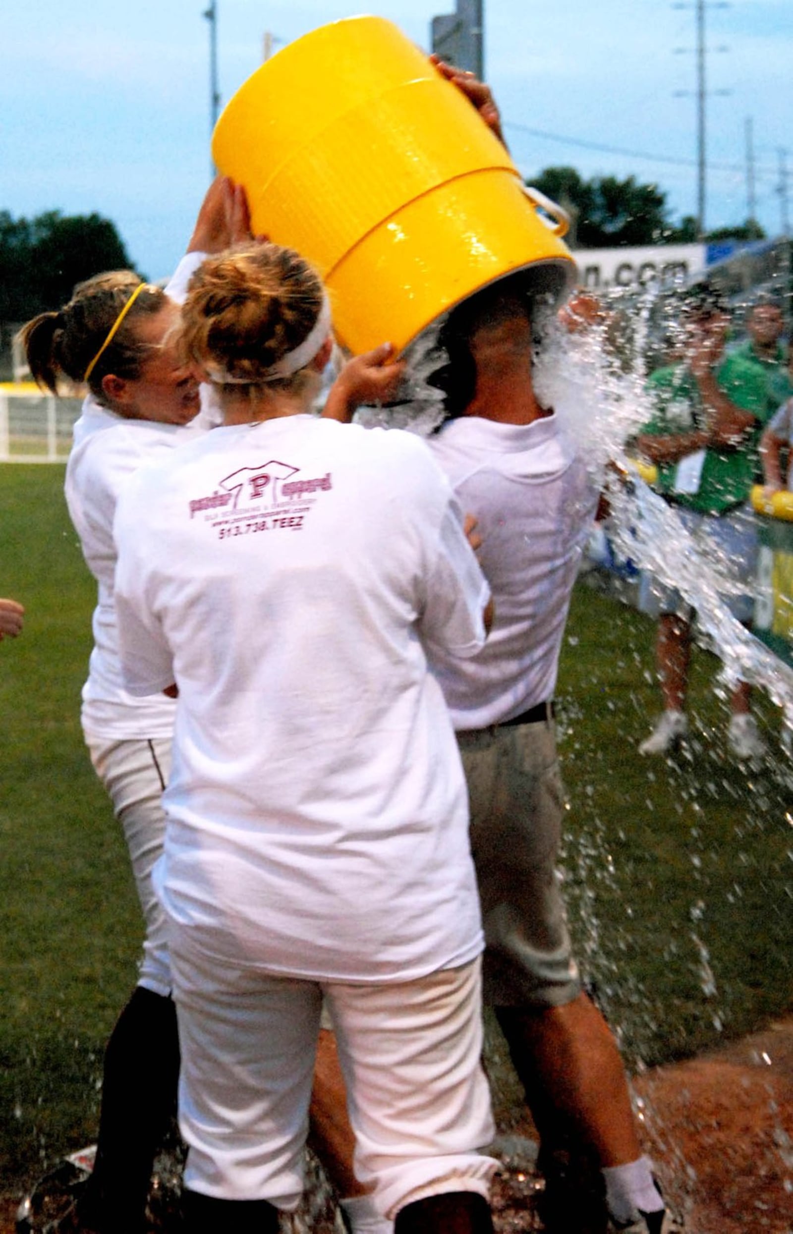 Ross High School softball coach Paul Fernandez gets a shower from his players June 6, 2009, after the Rams defeated Bellville Clear Fork 4-2 to win the Division II state championship at Firestone Stadium in Akron. CONTRIBUTED PHOTO BY DAVID A. MOODIE