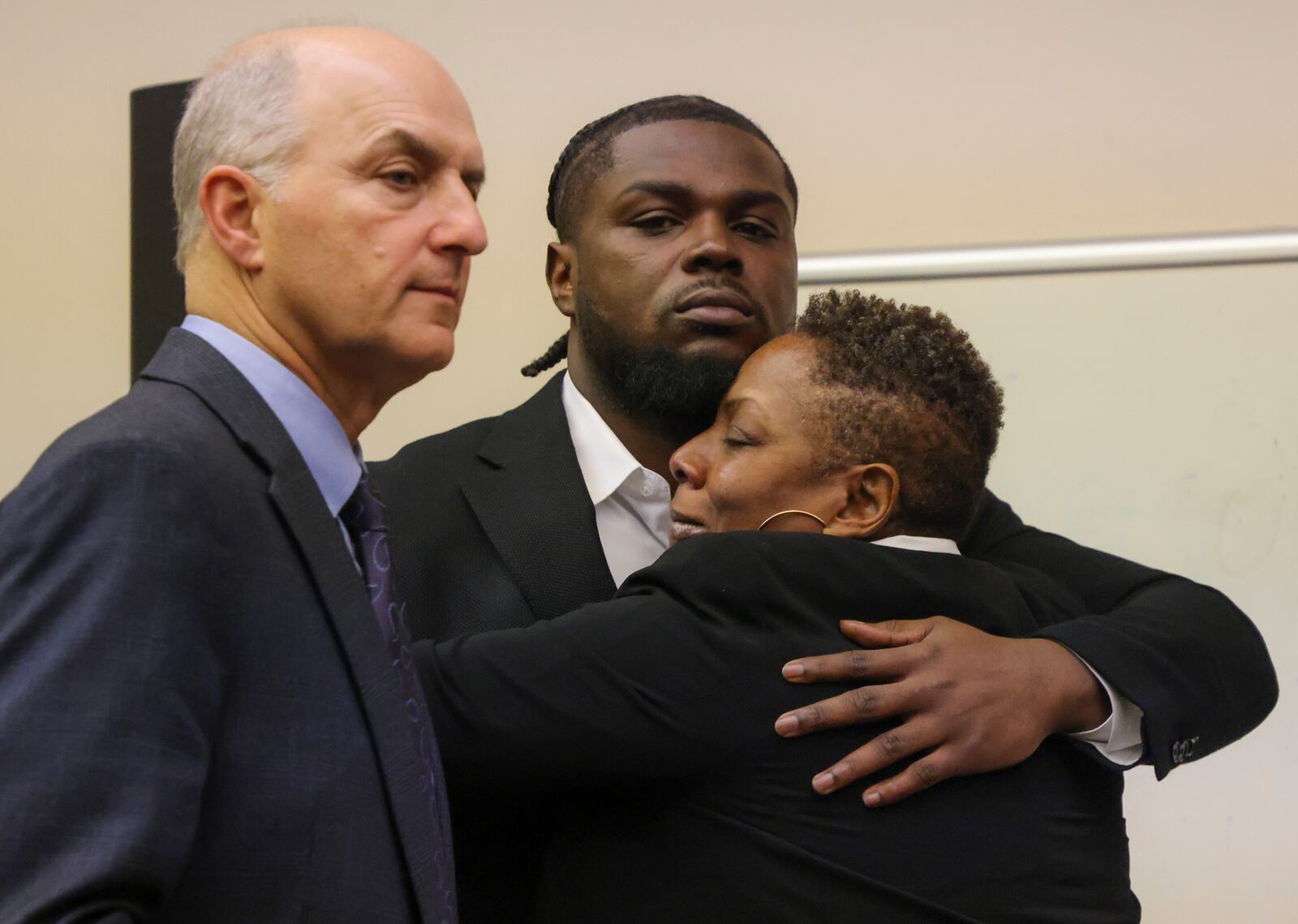 New England Patriots safety Jabrill Peppers hugs from his mother Ivory Bryant after a jury found him not guilty in his assault and battery trial, Friday, Jan. 24, 2025, in Quincy, Mass. At left is his attorney Marc Brofsky. (Matthew J Lee/The Boston Globe via AP, Pool)