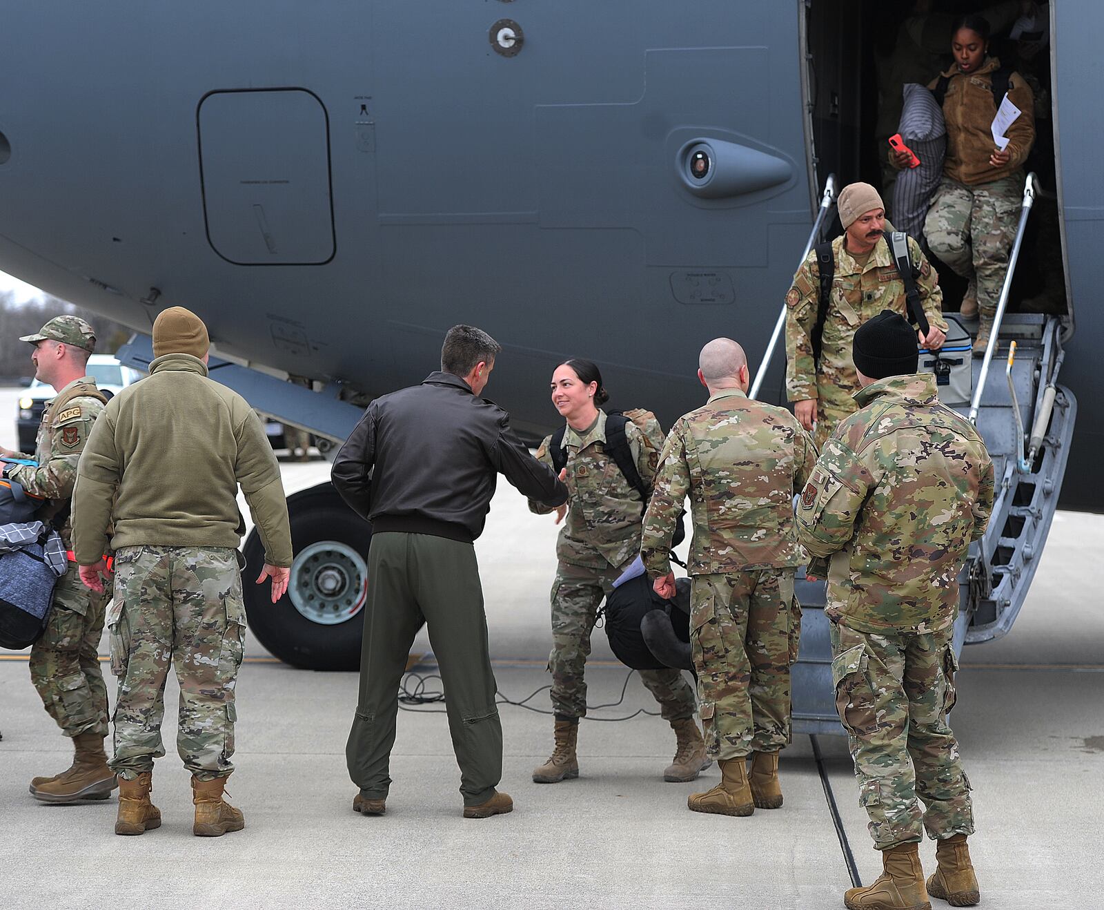 Airmen are greeted Thursday, Jan. 4, 2024 my family and friends after arriving home in a quartet of C-17 Globemaster cargo planes, the Airmen returned to Wright-Patterson Air Force Base from more than two months deployed at an undisclosed location. MARSHALL GORBY\STAFF