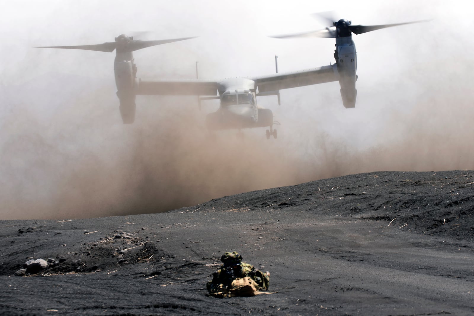 FILE - An MV-22 Osprey takes off as Japan Ground Self-Defense Force guards the landing zone during a joint military drill with U.S. Marines in Gotemba, southwest of Tokyo, March 15, 2022. (AP Photo/Eugene Hoshiko, File)