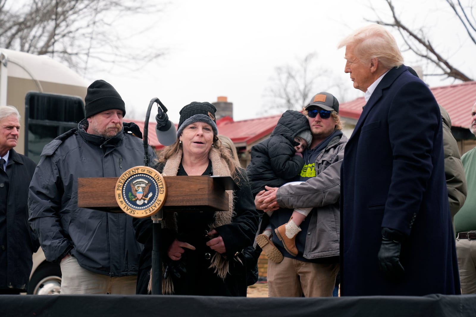 President Donald Trump listens as resident Kim West speaks, as Trump meets with homeowners affected by Hurricane Helene in Swannanoa, N.C., Friday, Jan. 24, 2025. (AP Photo/Mark Schiefelbein)