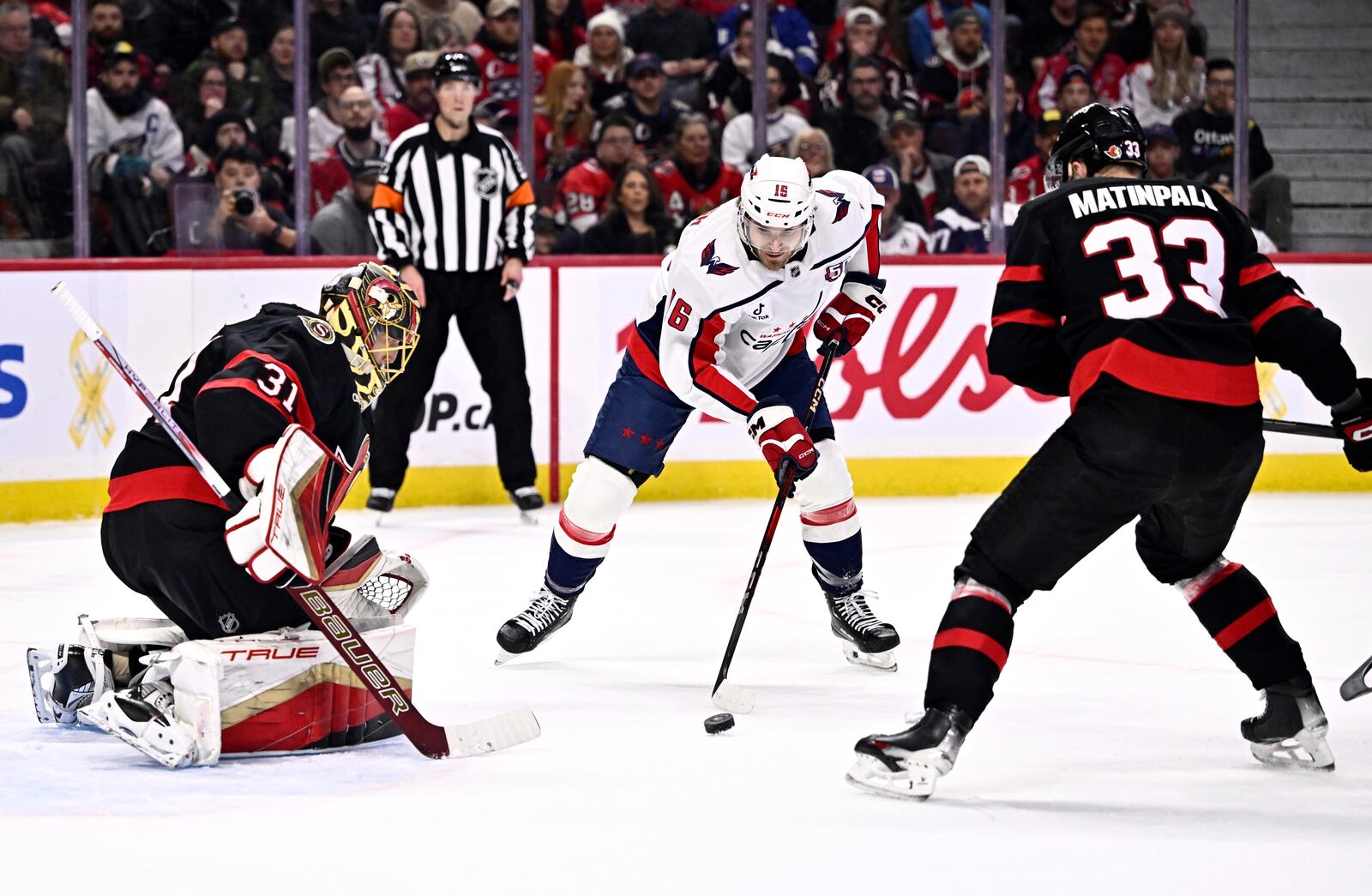 Washington Capitals' Taylor Raddysh (16) tries to shoot against Ottawa Senators goaltender Anton Forsberg (31) during first-period NHL hockey game action in Ottawa, Ontario, Thursday, Jan. 30, 2025. (Justin Tang/The Canadian Press via AP)