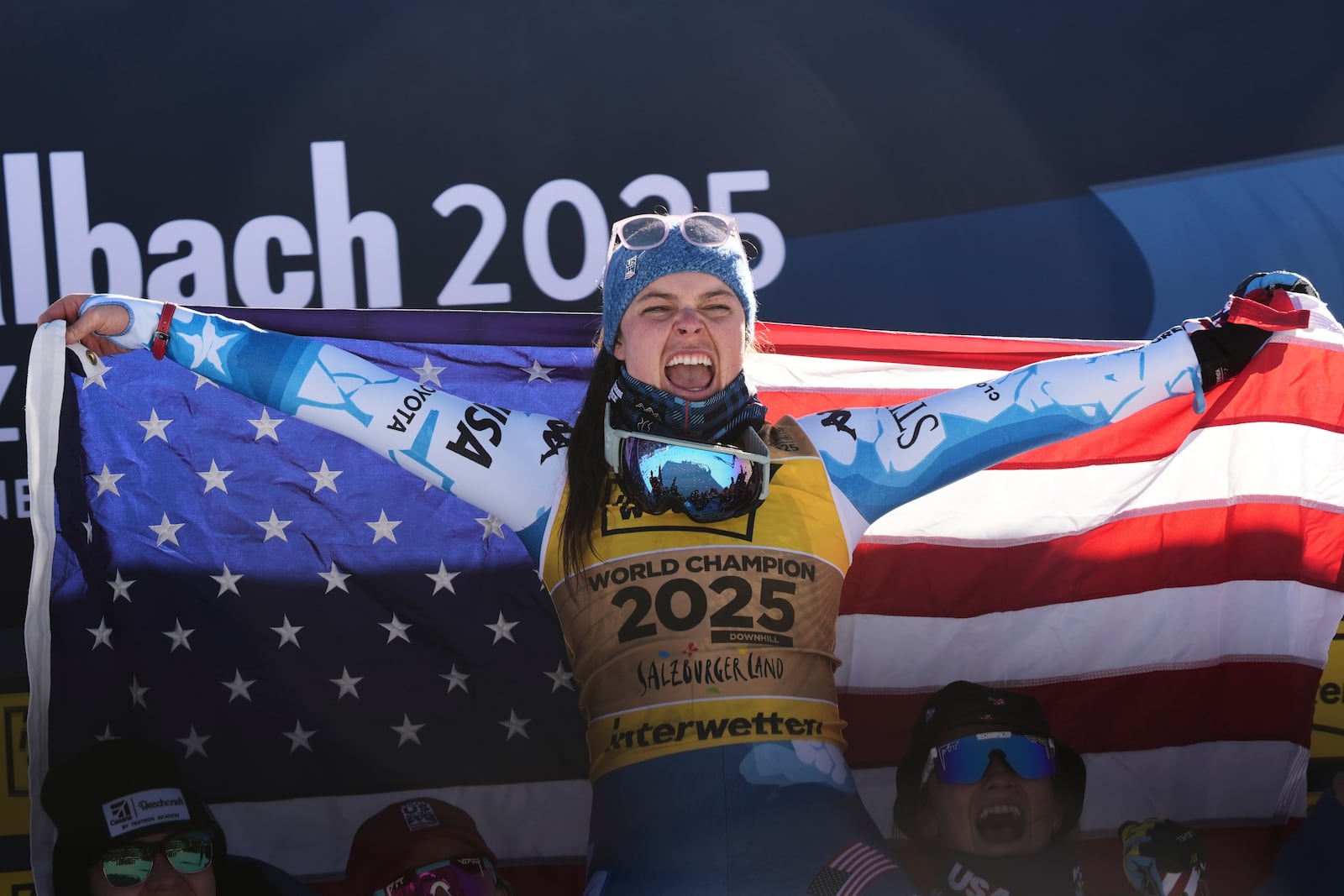 United States' Breezy Johnson celebrates on the podium after winning the gold medal in a women's downhill race, at the Alpine Ski World Championships, in Saalbach-Hinterglemm, Austria, Saturday, Feb. 8, 2025. (AP Photo/Giovanni Auletta)