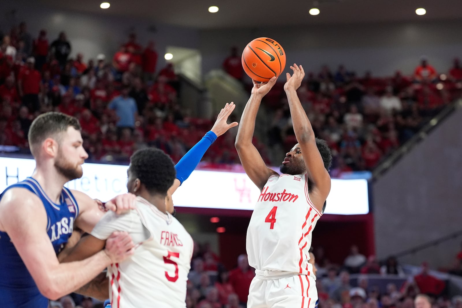 Houston's L.J. Cryer (4) shoots against Kansas during the second half of an NCAA college basketball game Monday, March 3, 2025, in Houston. (AP Photo/David J. Phillip)