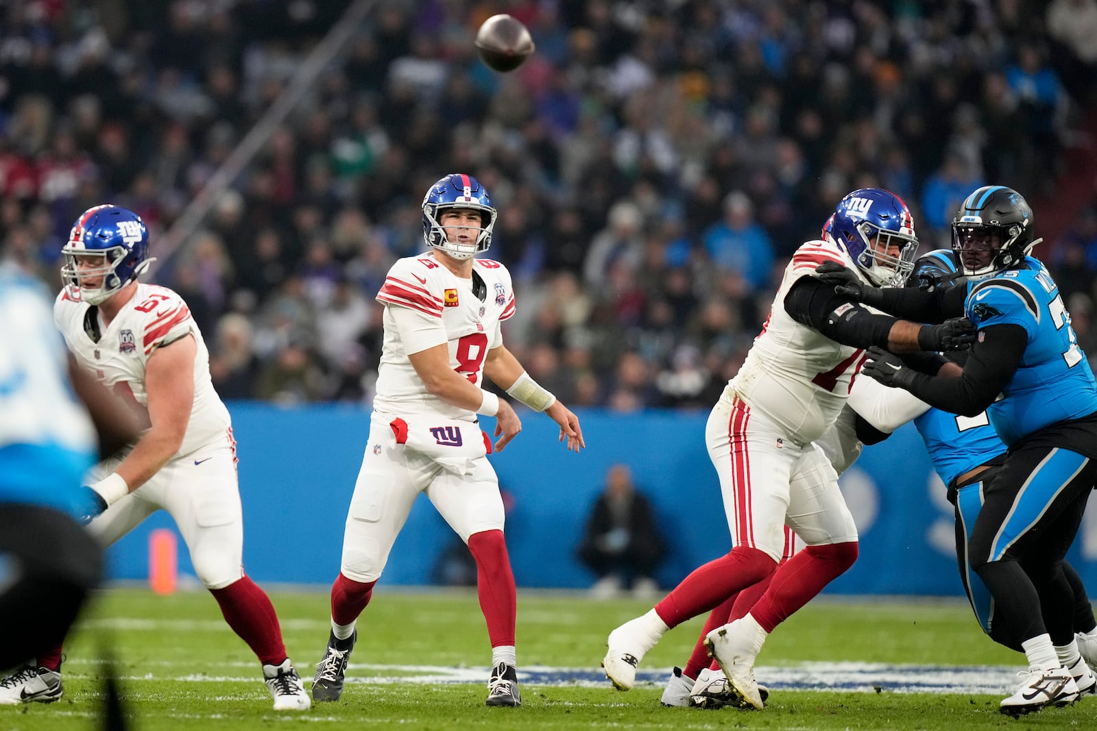 New York Giants quarterback Daniel Jones passes against the Carolina Panthers during the first half of an NFL football game, Sunday, Nov. 10, 2024, in Munich, Germany. (AP Photo/Matthias Schrader)