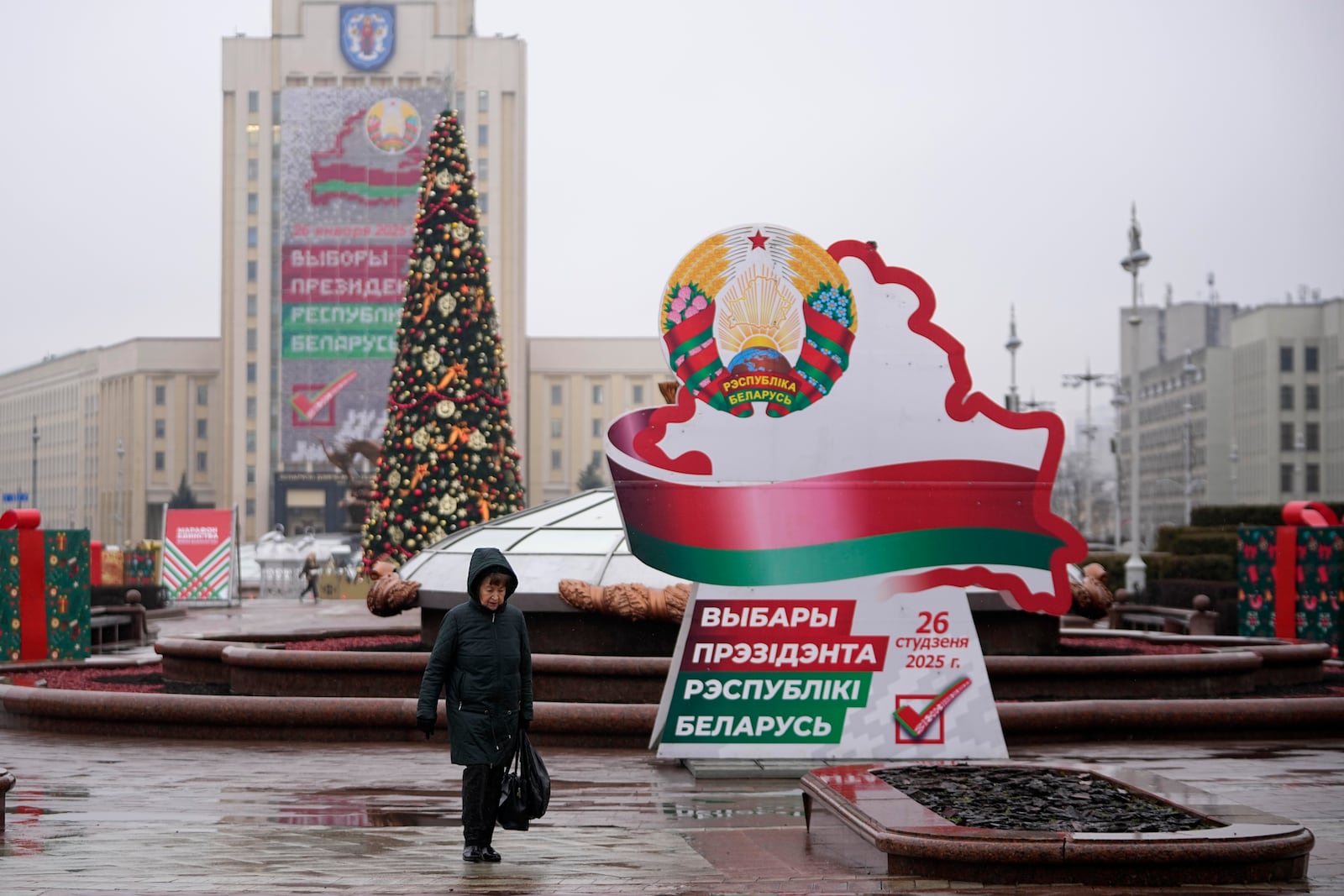 A woman walks past election billboards ahead of presidential elections in Minsk, Belarus, Friday, Jan. 24, 2025. (AP Photo/Pavel Bednyakov)