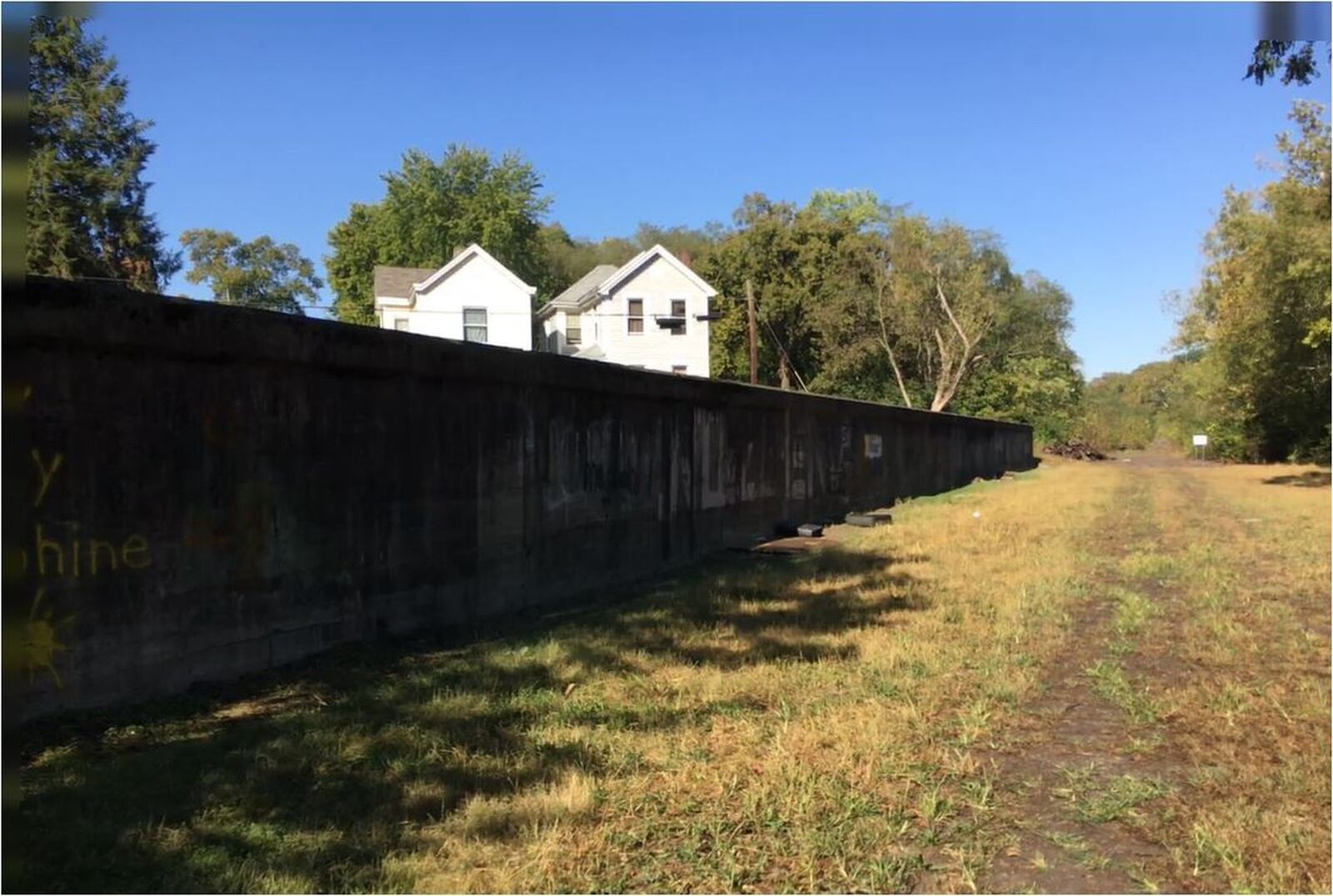 The Beltline hiking/biking trail runs through woods, next to a stream, and beside and among various neighborhoods on Hamilton’s West Side. MIKE RUTLEDGE/STAFF