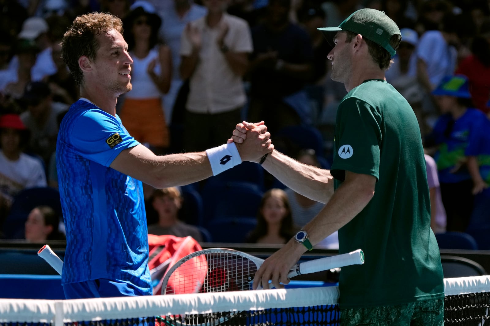 Tommy Paul, right, of the U.S. is congratulated by Roberto Carballes Baena of Spain following their third round match at the Australian Open tennis championship in Melbourne, Australia, Friday, Jan. 17, 2025. (AP Photo/Manish Swarup)